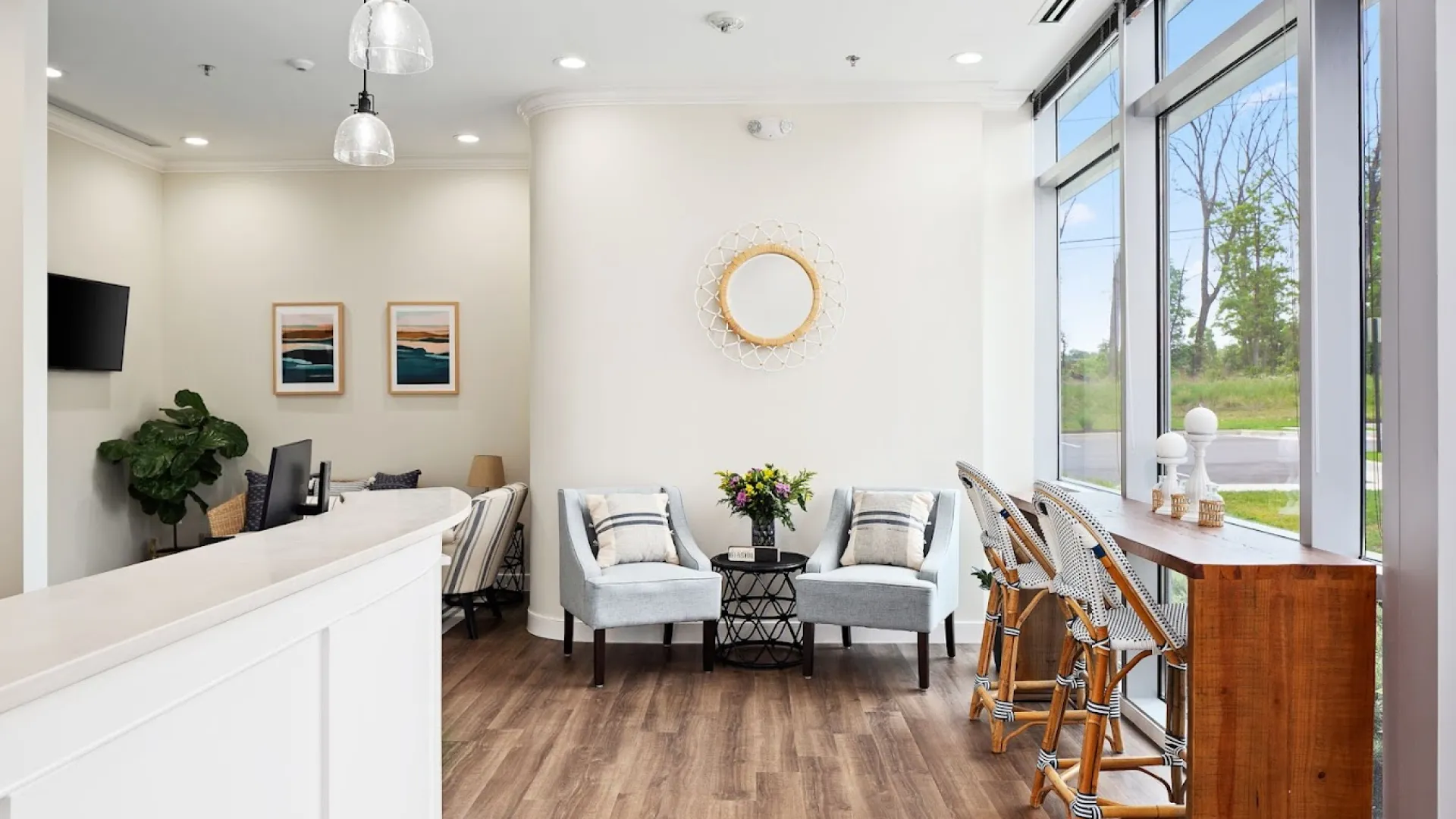 Bright, modern reception area with comfortable seating and large windows overlooking greenery.