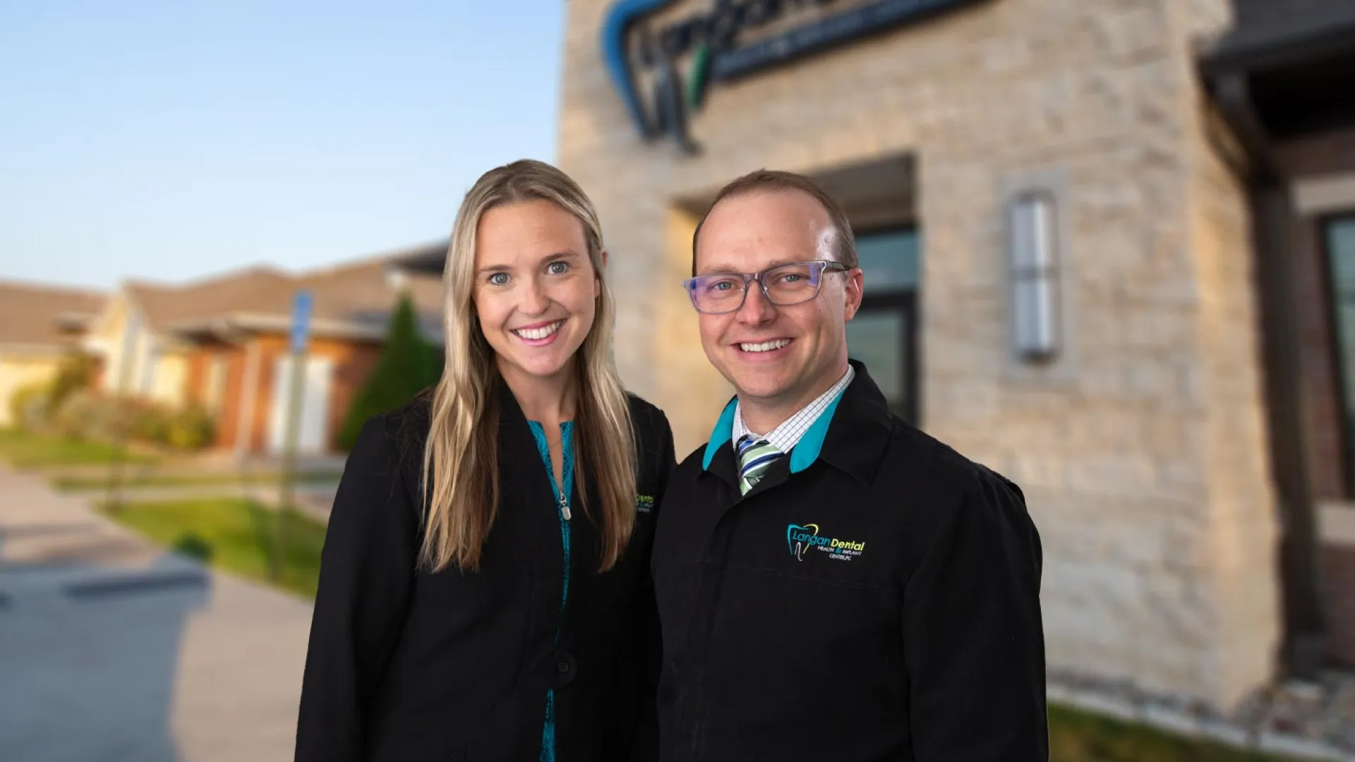 a man and woman standing together outside