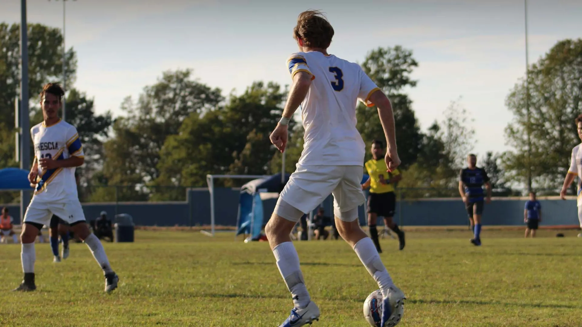 Soccer player in action on the field, wearing jersey number 3 during a match.
