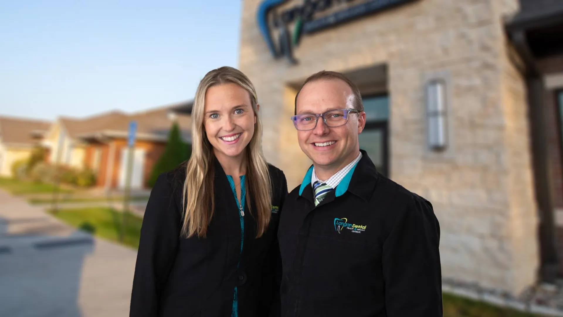 a man and woman standing together outside