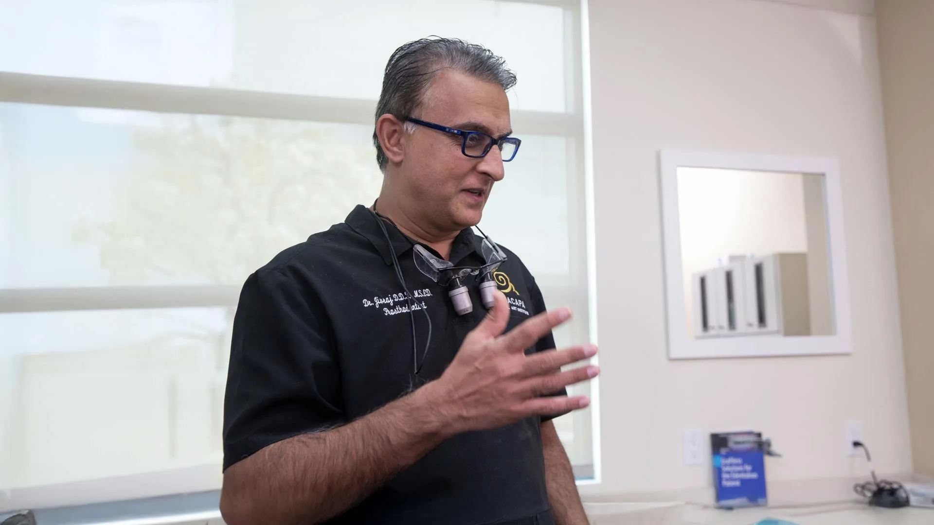 A dentist explaining dental procedures in a modern clinic environment.