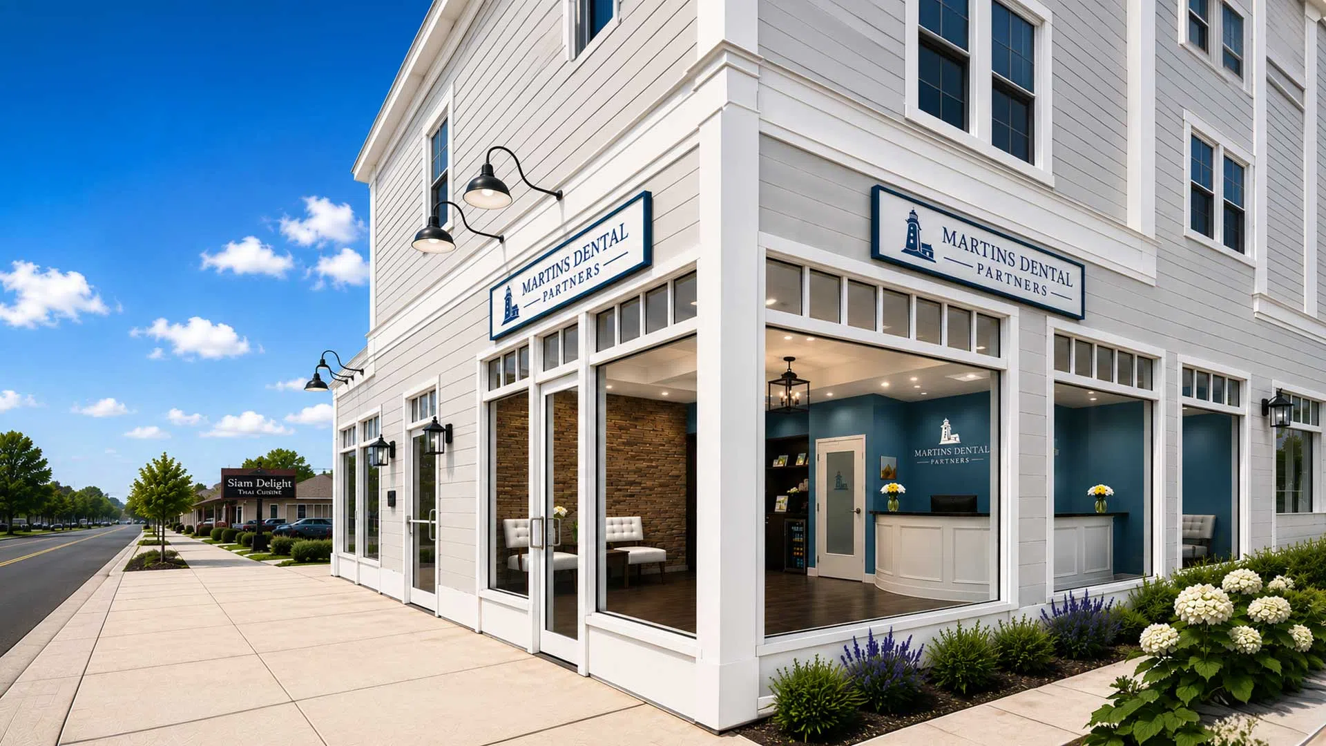 Corner view of Martins Dental Partners building with large windows and modern storefront on a sunny day