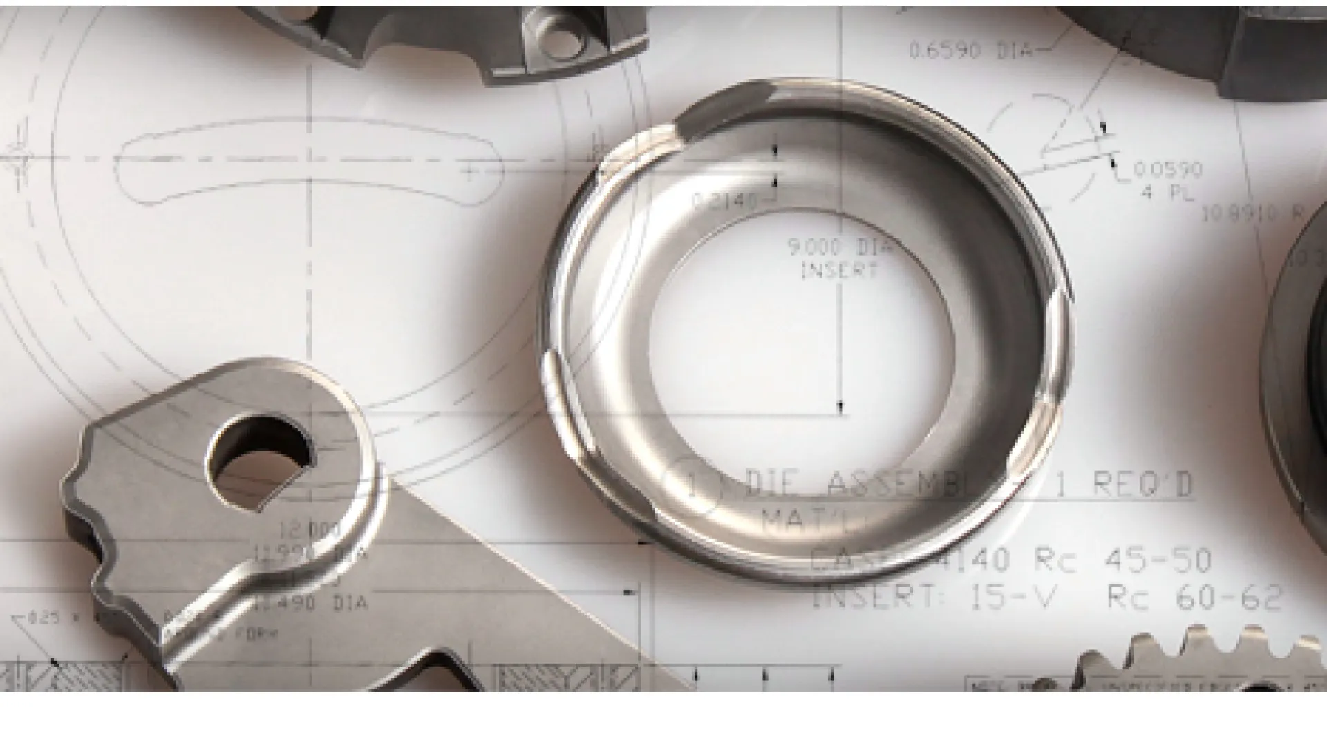 Close-up of precision metal mechanical parts on technical blueprint drawings for engineering design.