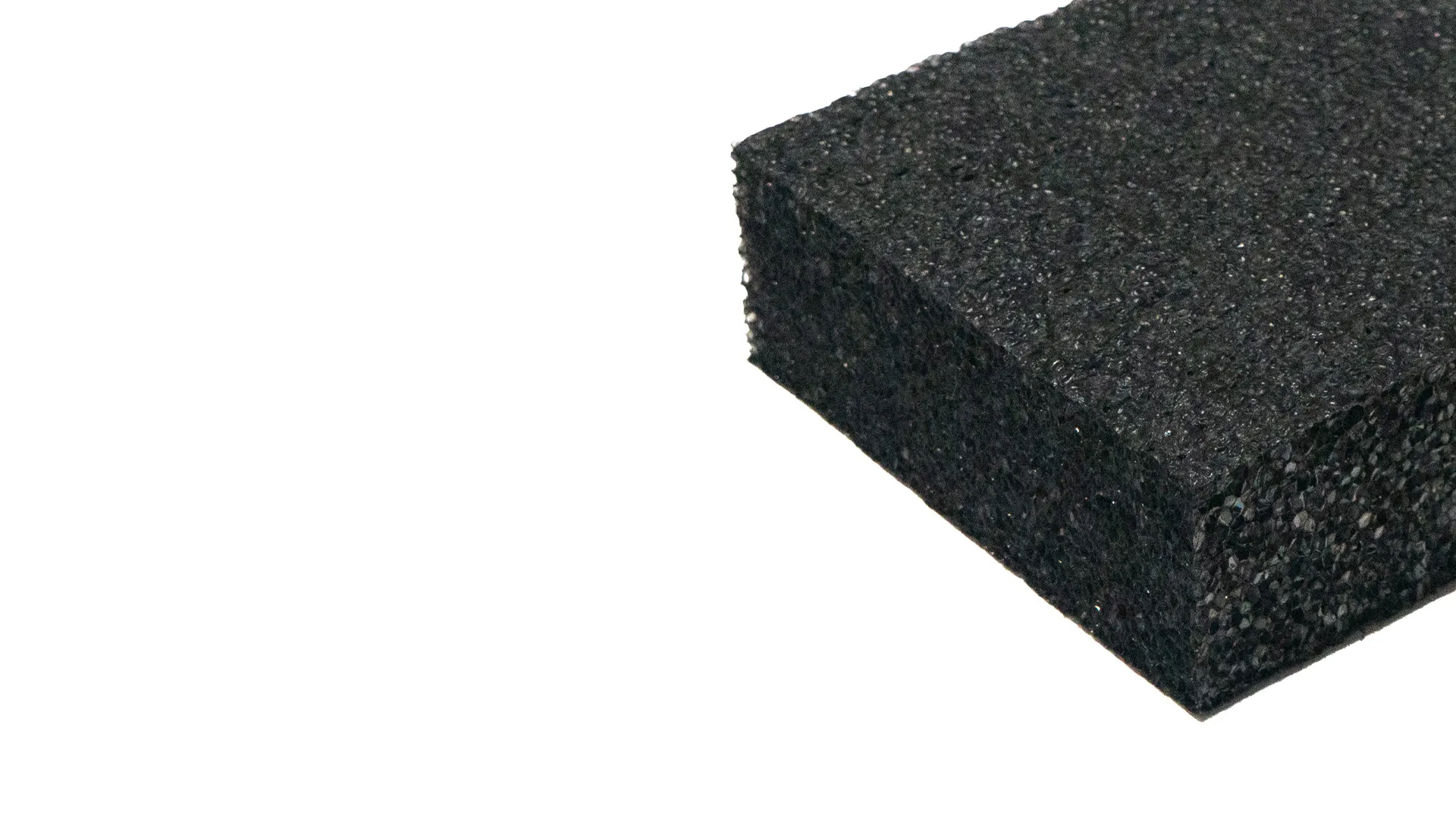 Close-up of a black foam rubber block showcasing its porous, textured surface and rectangular shape