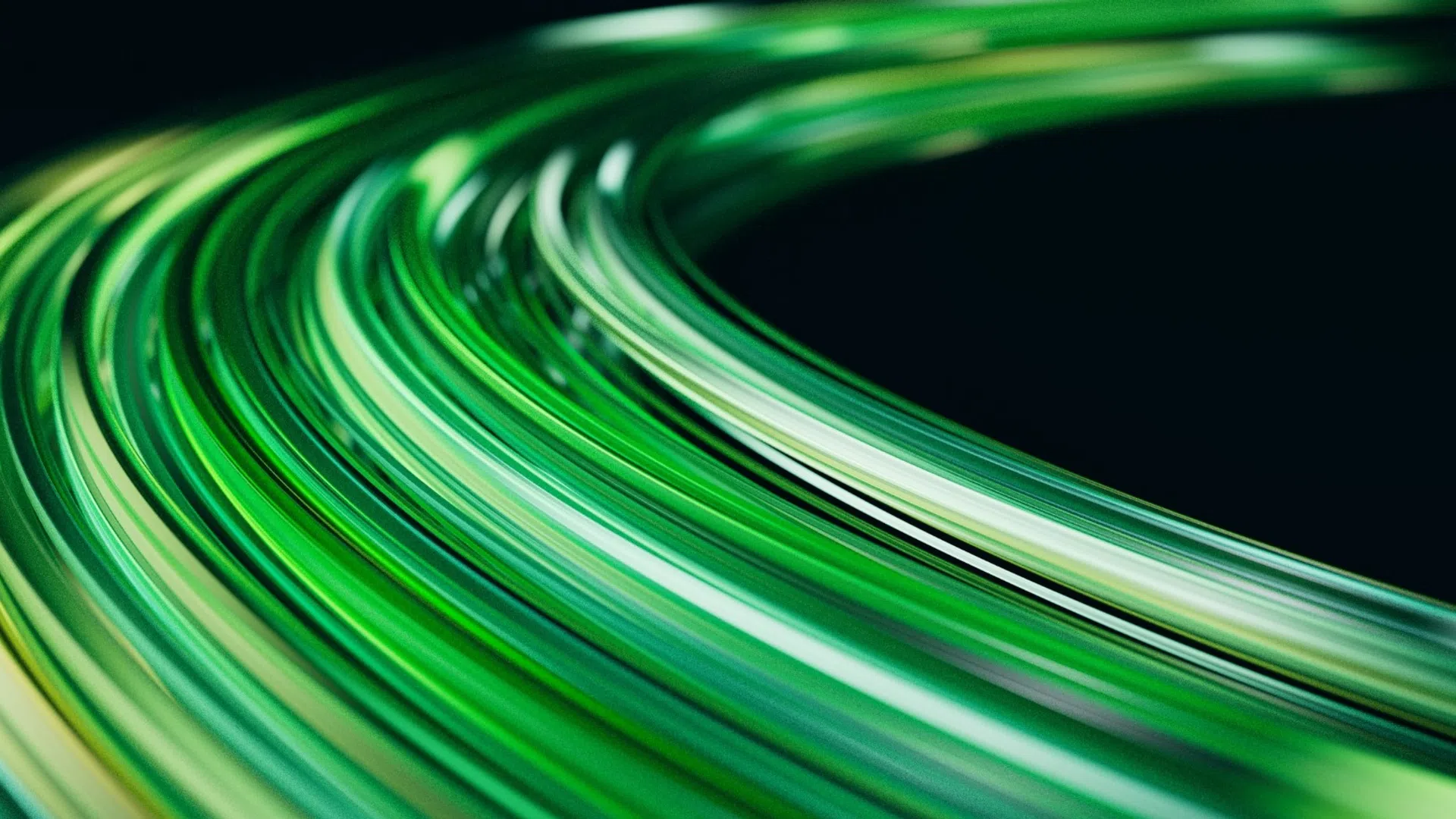 Abstract curved streaks of green light on a dark background creating a dynamic flowing motion effect.