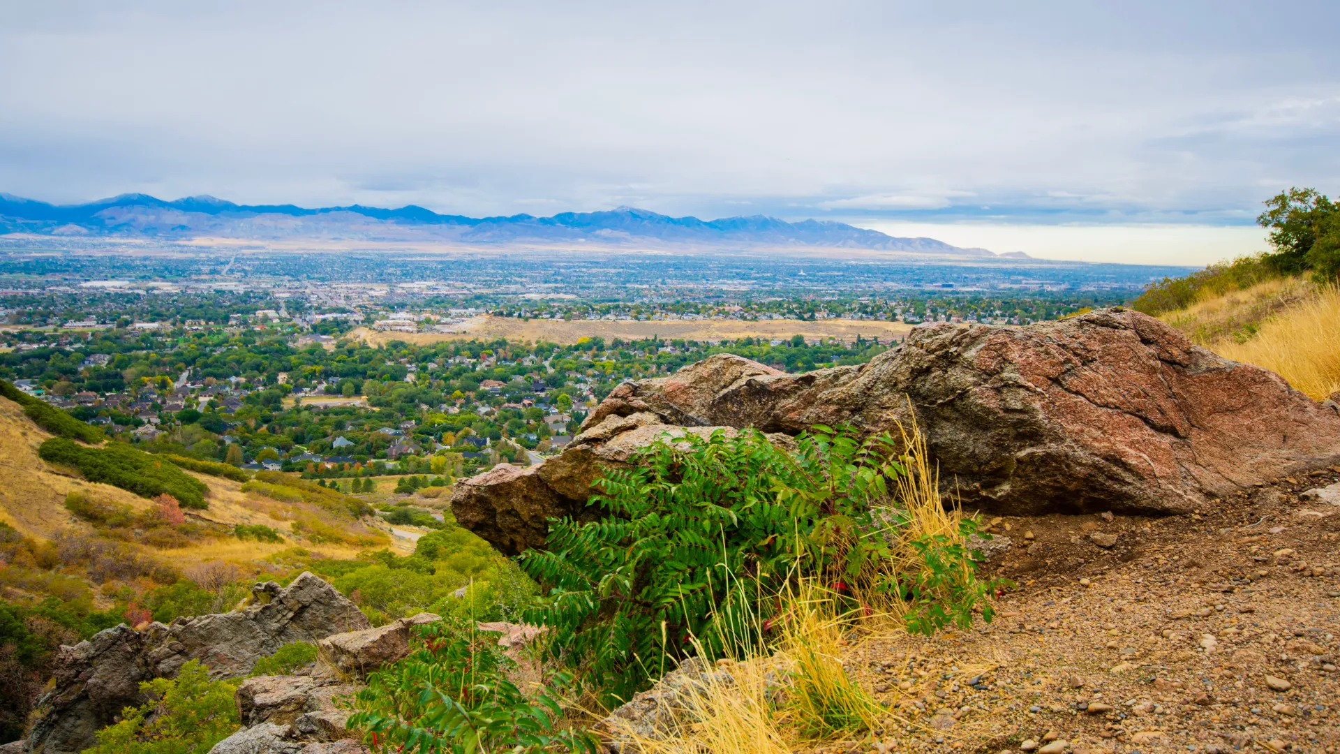 a rocky hillside with a town in the distance