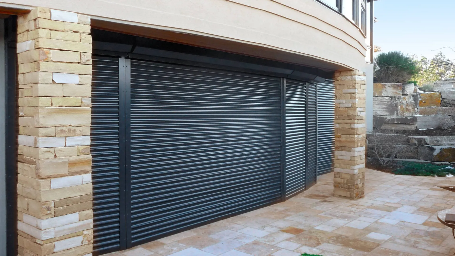 a garage door with a brick wall