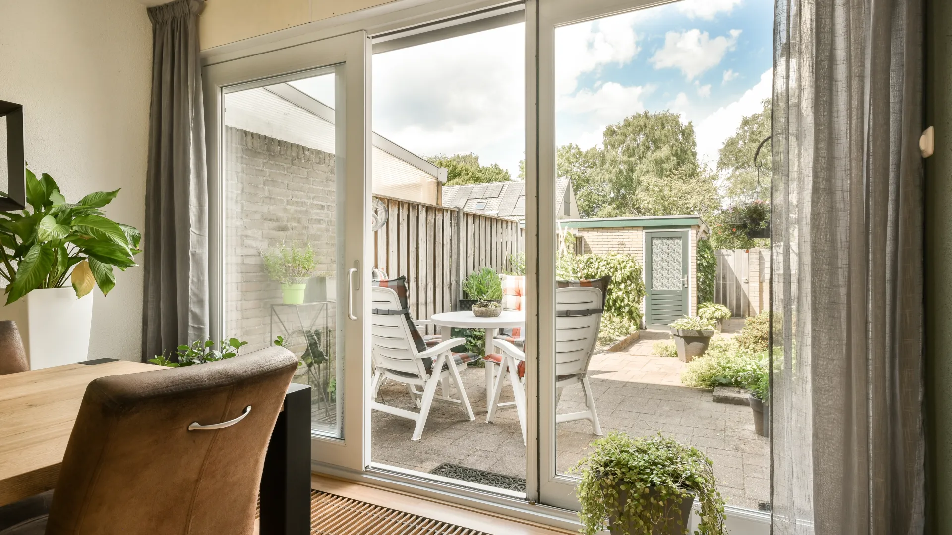 a patio with a table and chairs