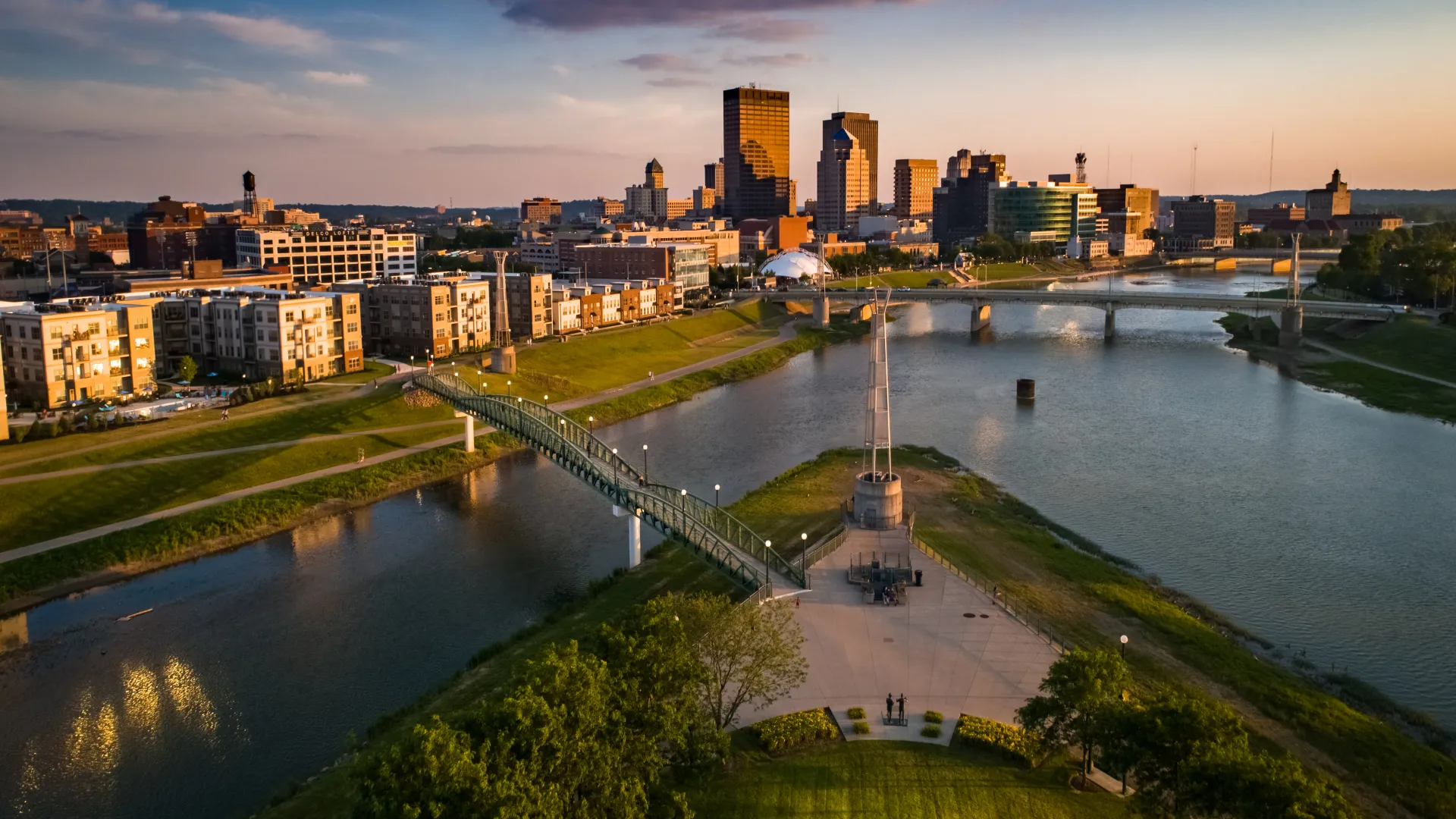 a bridge over a river with a city in the background