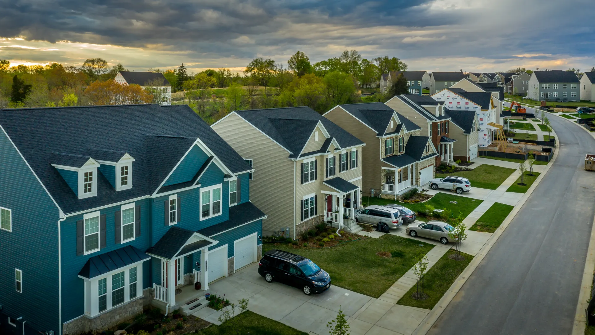 a neighborhood street with cars parked