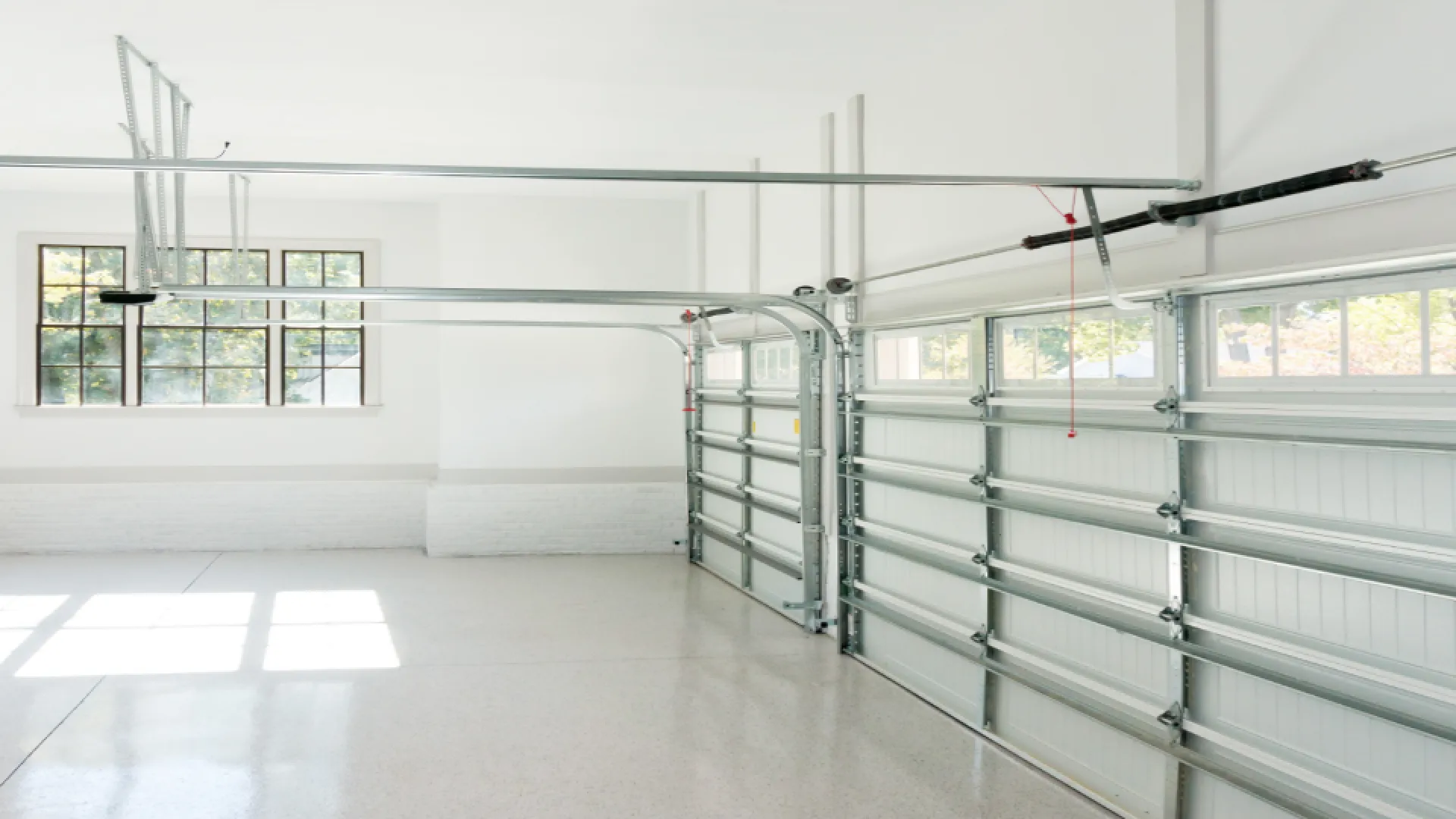 a room with a white floor and windows