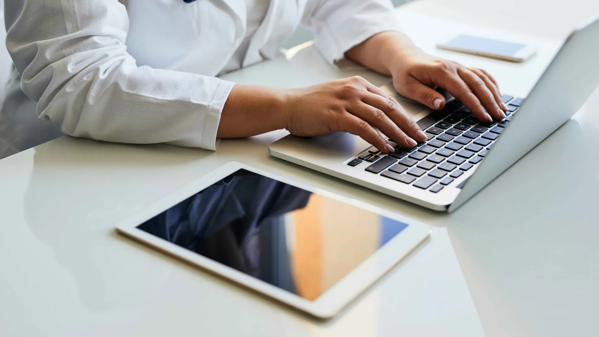 a doctor typing on a laptop