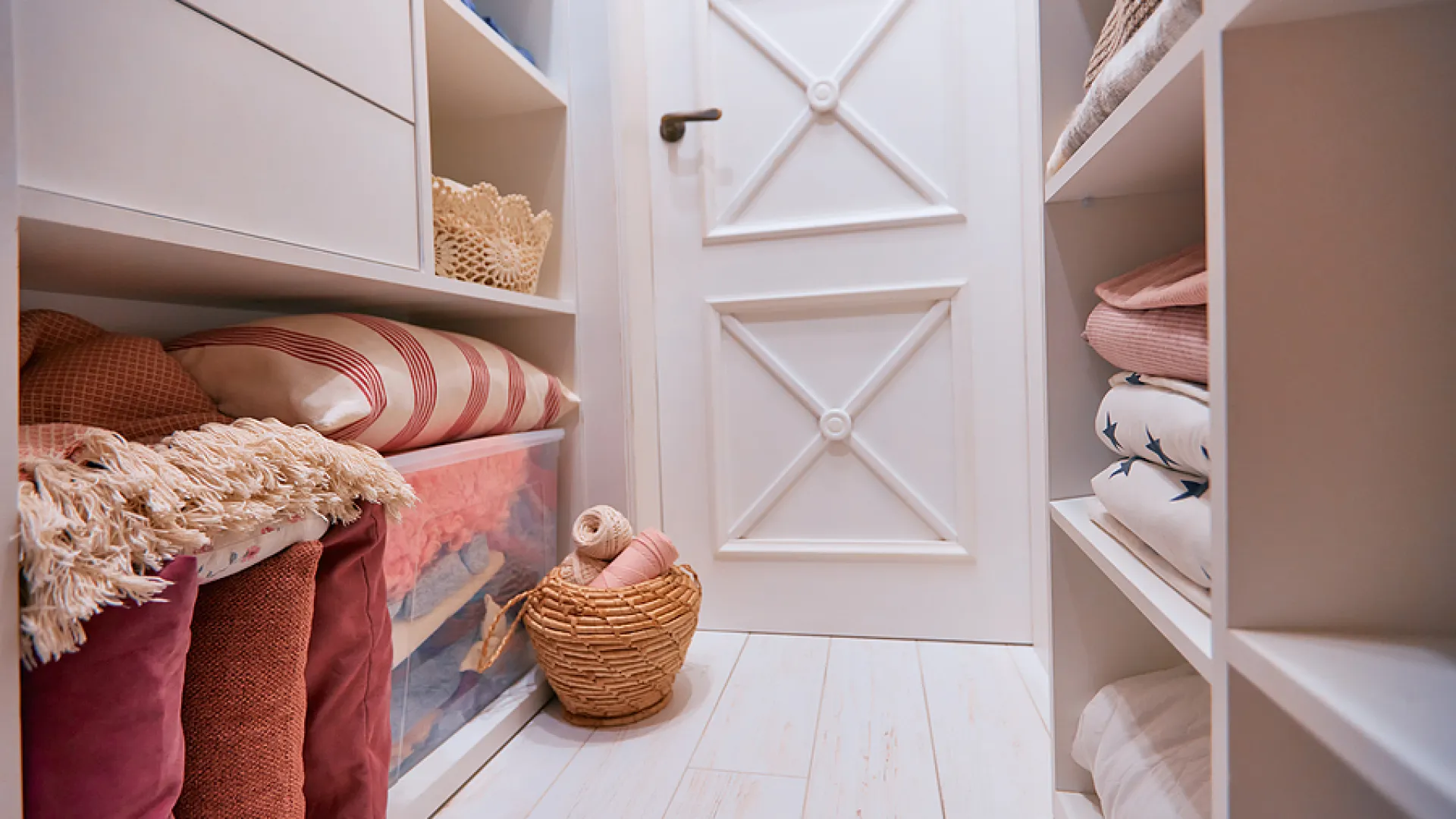 a room with a bed and a shelf with a basket and a basket