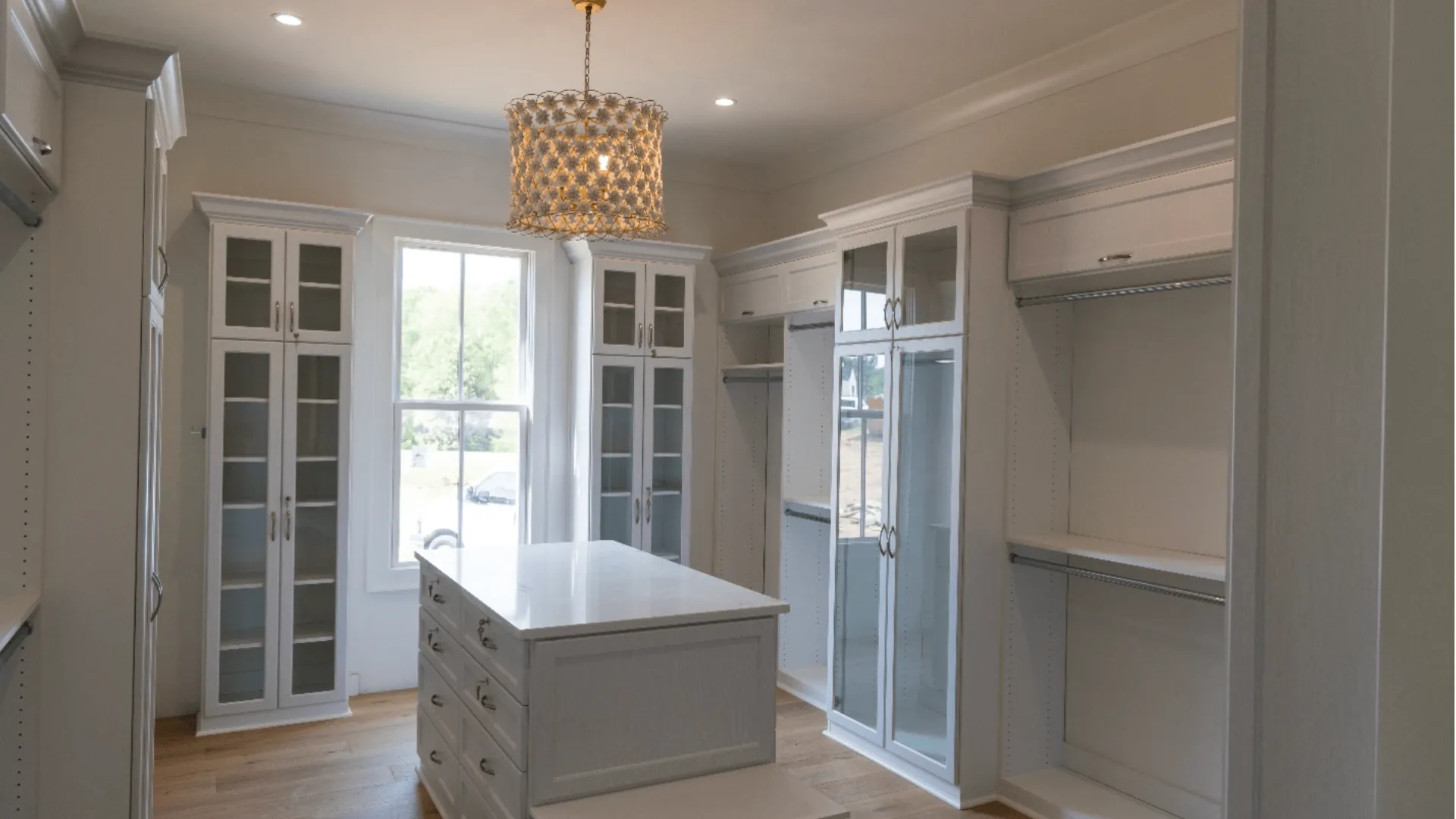 White cabinets and a chandelier