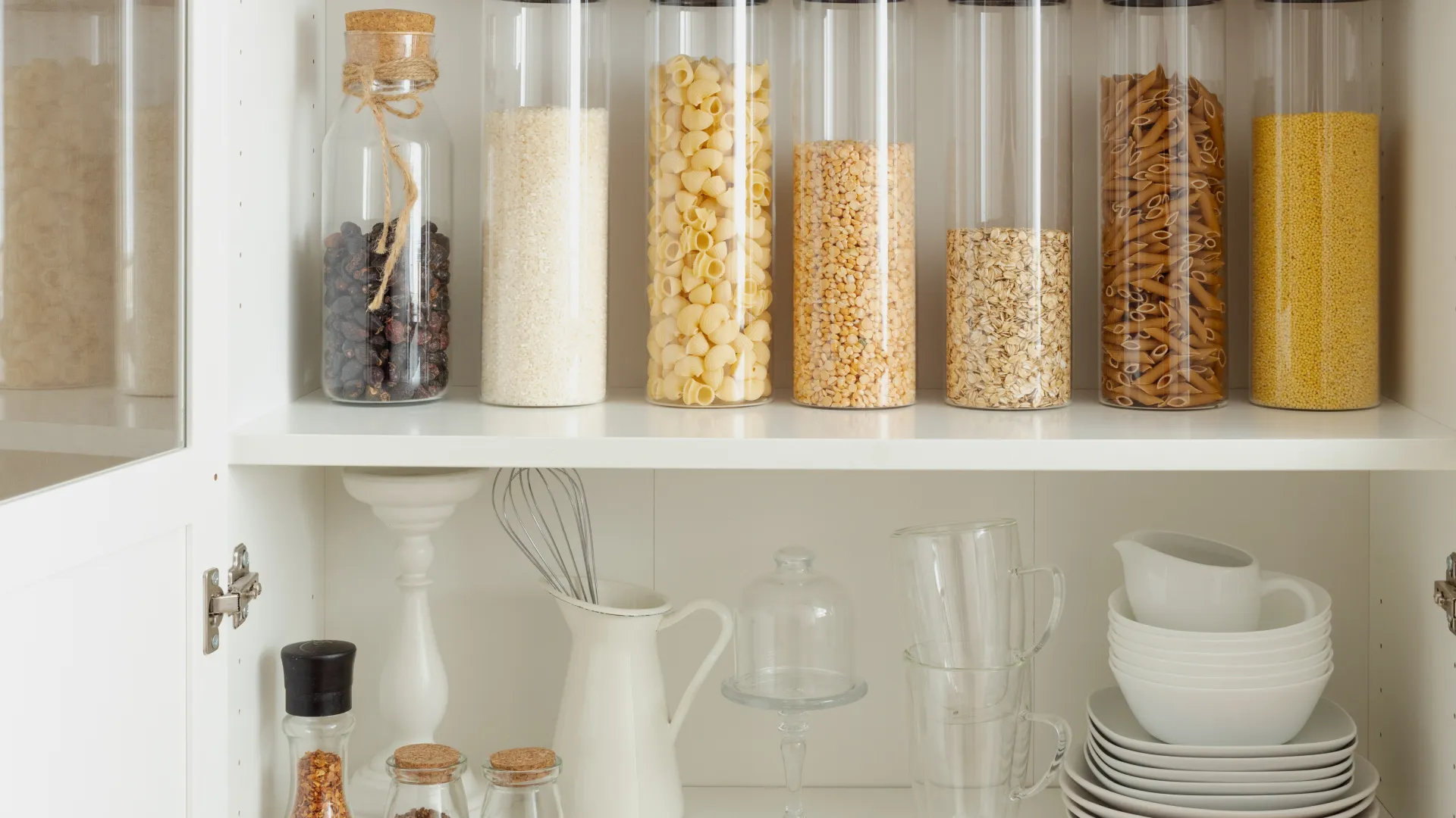 a shelf with glass jars and candles