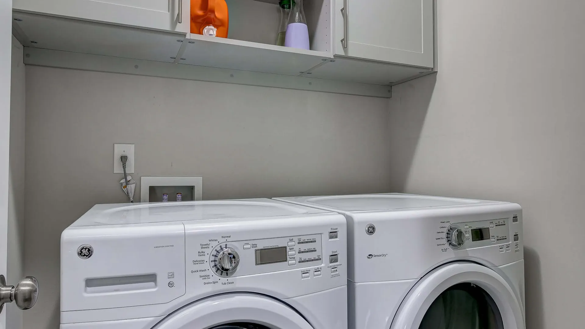 a washing machine and dryer in a room