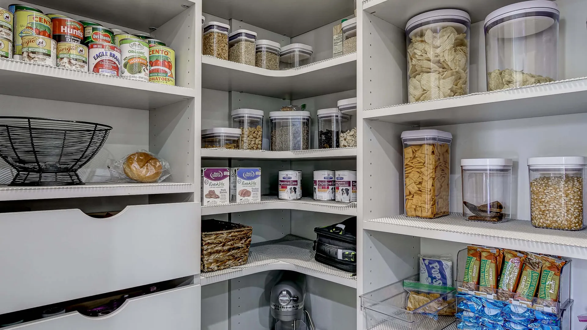 a kitchen with shelves full of food