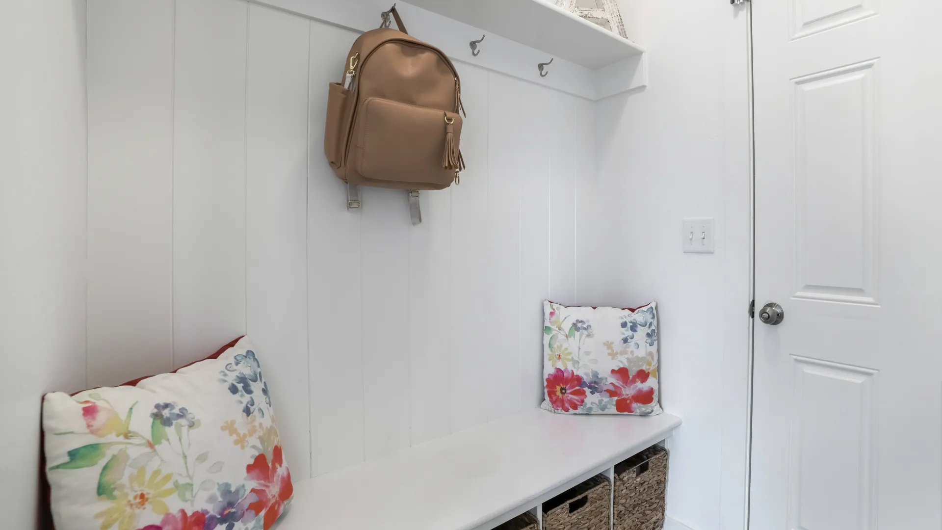 a purse on a wall in a mud room