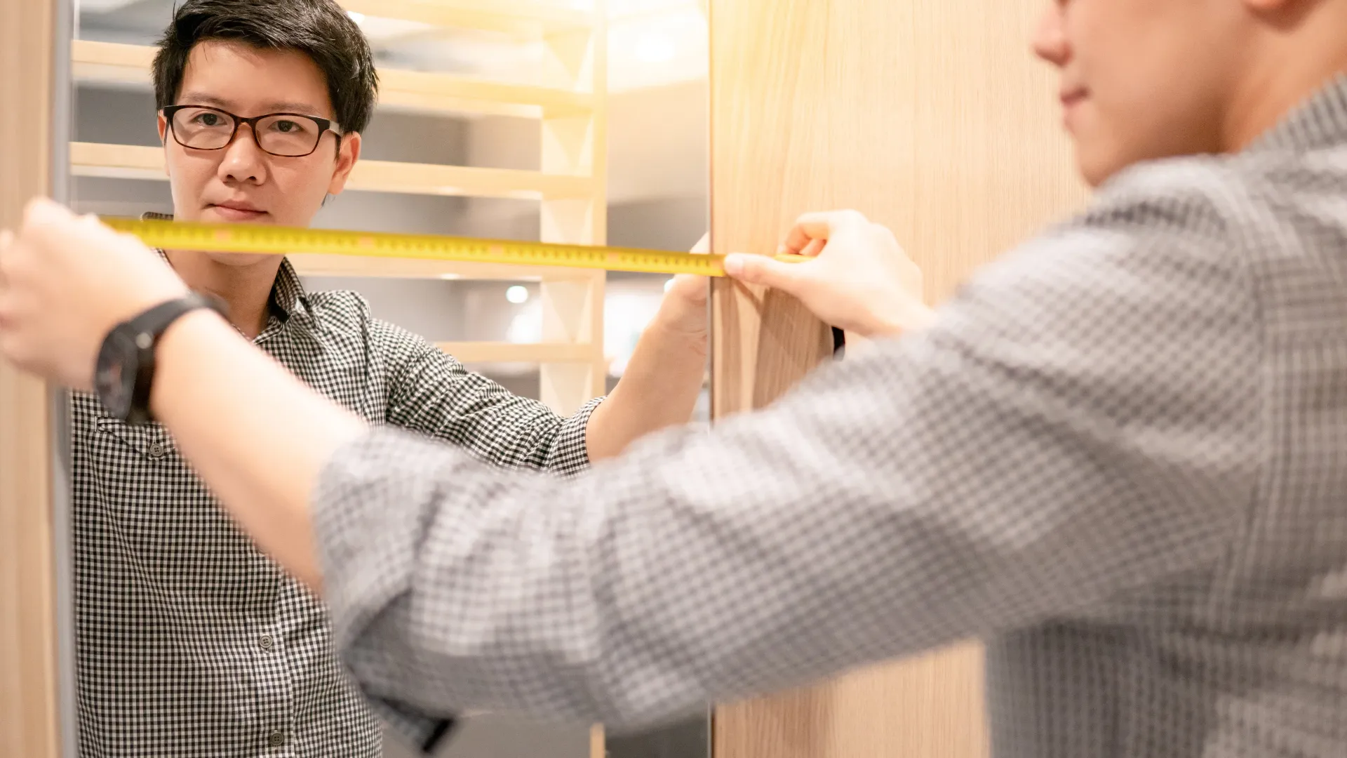 a man holding  yellow measuring tape