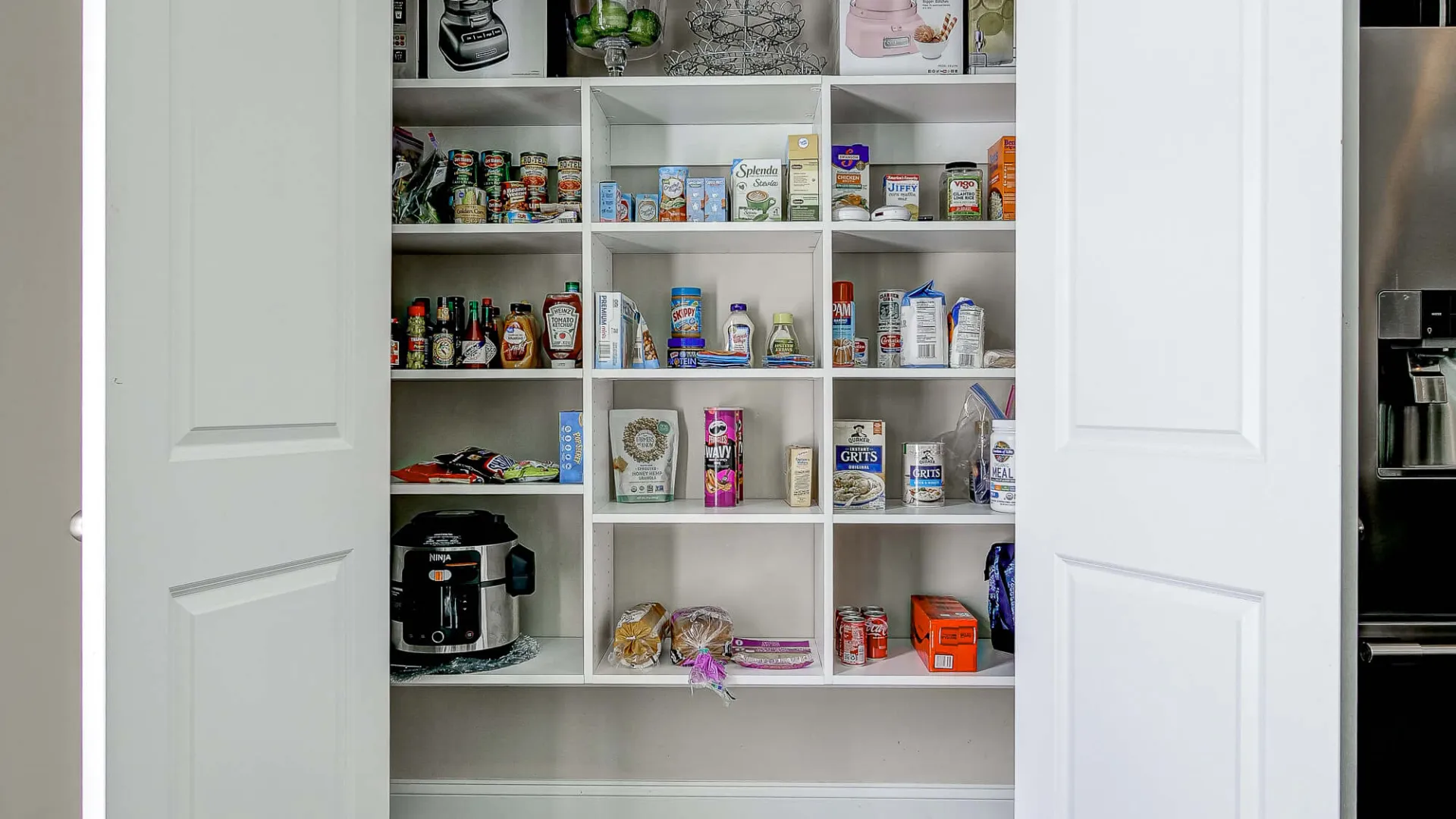 a white shelving unit with shelves