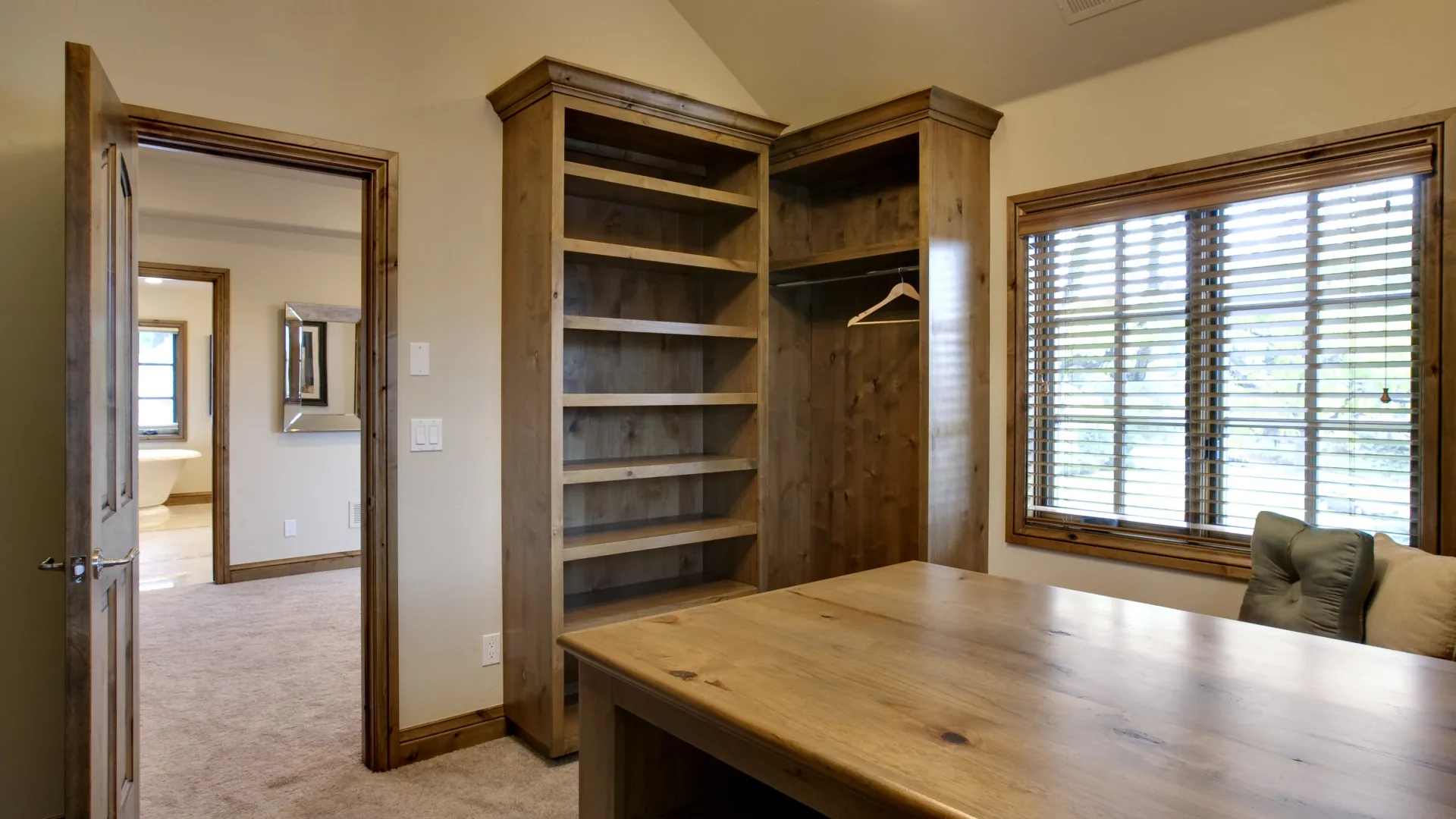 a walk-in with a table and wood shelves