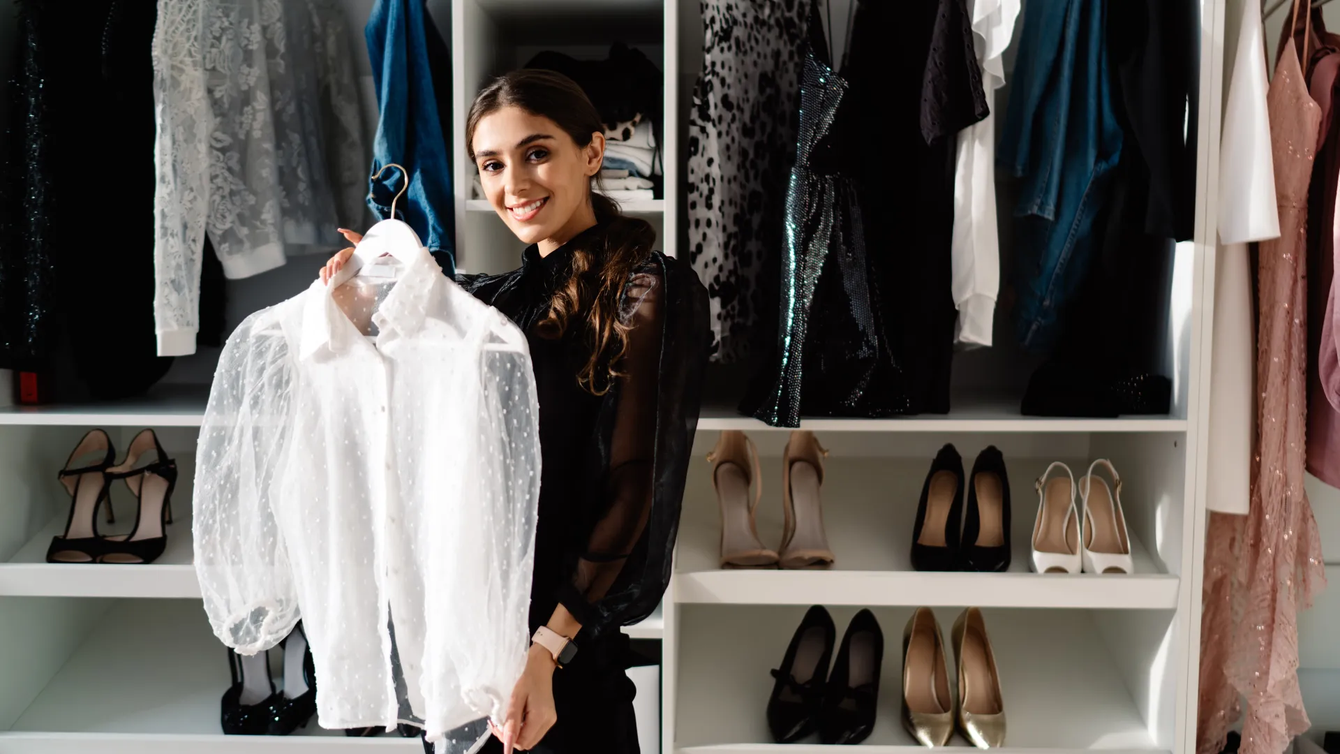 a person posing in front of a display of shoes