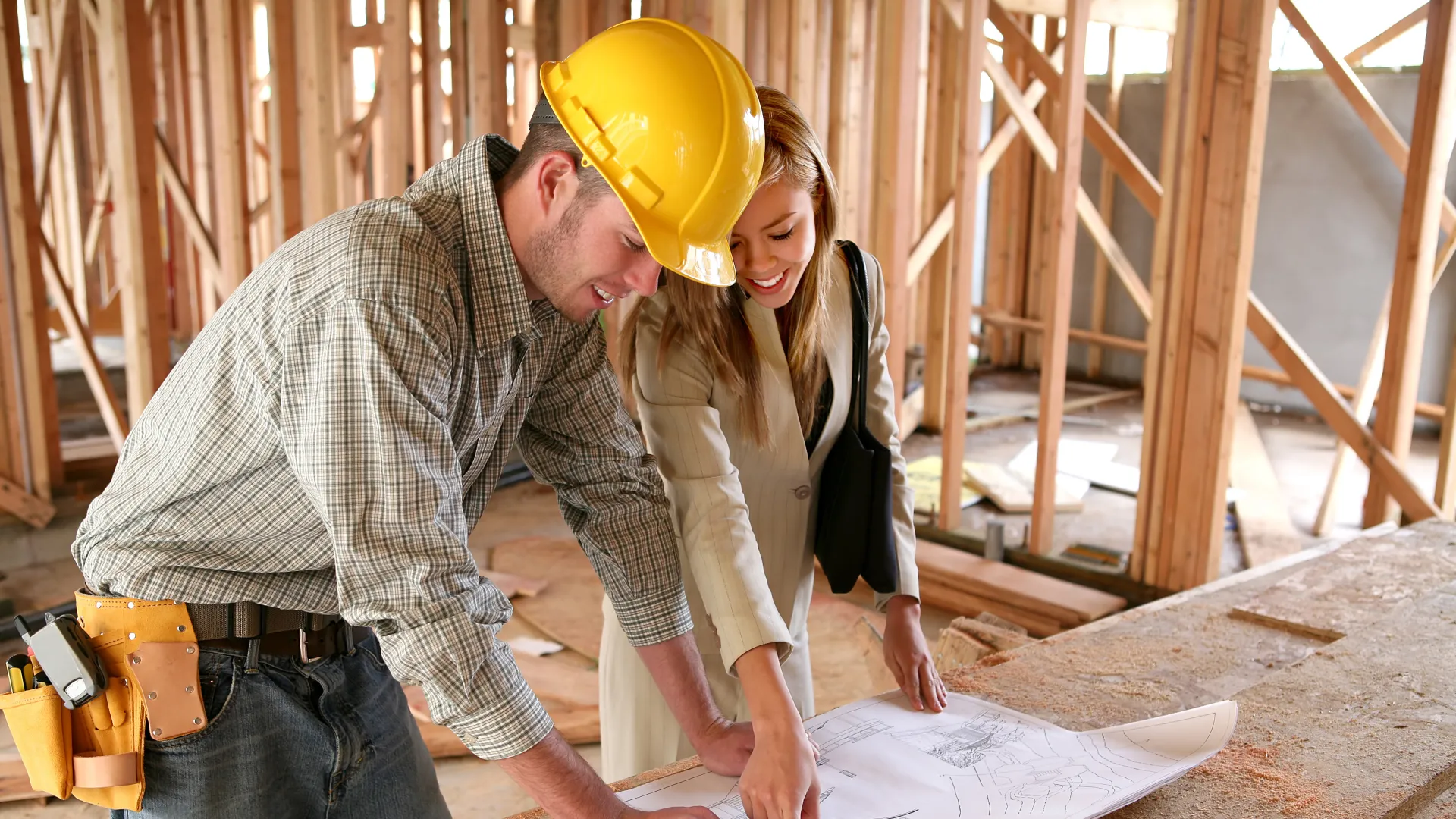 Home Builder and SpaceMakers Designer Reviewing Blueprints