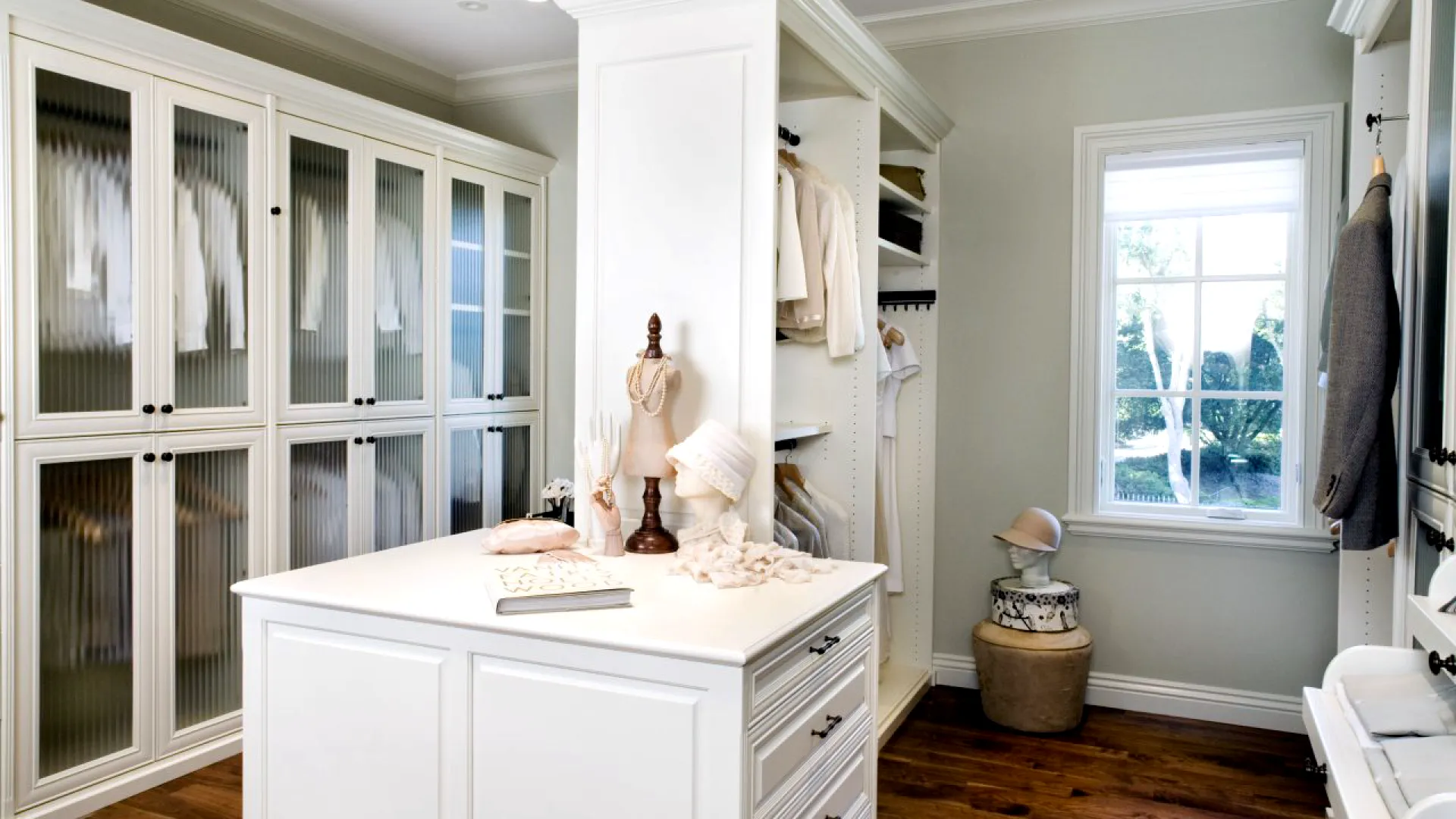 a white kitchen with a white counter top and a statue on top