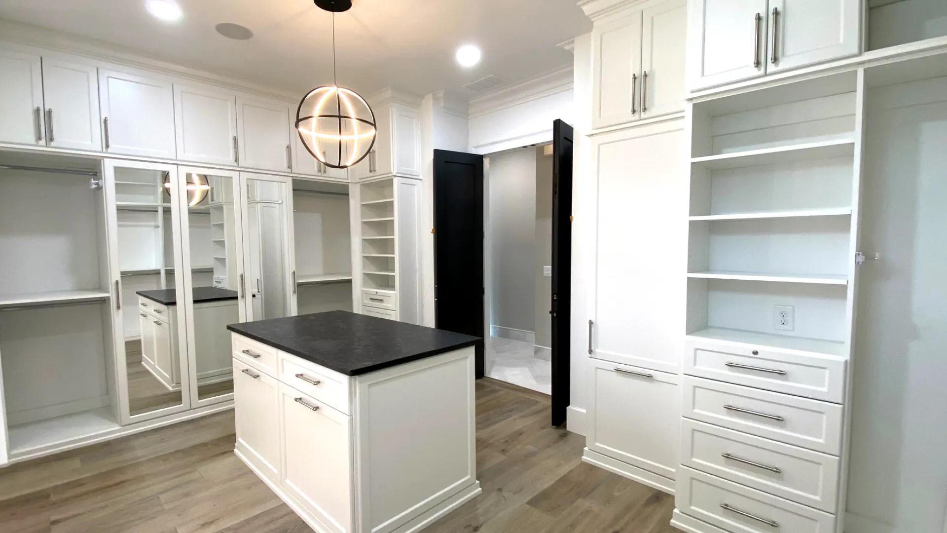 a kitchen with white cabinets