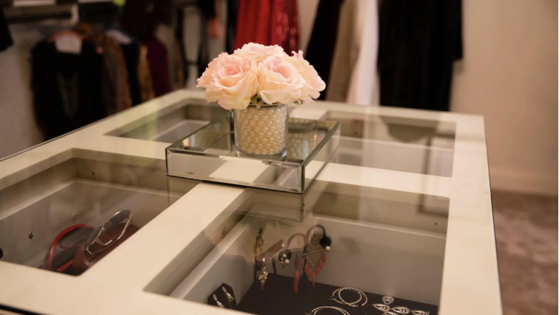 a vase with flowers on a glass table