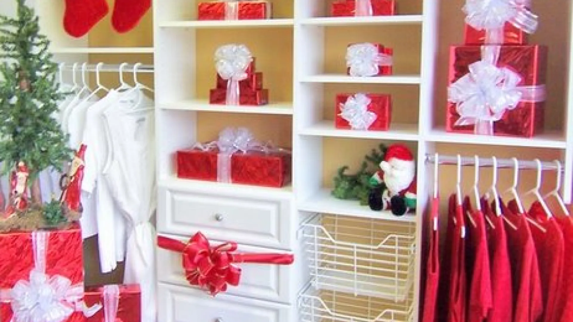 a white shelving unit with clothes and a basket
