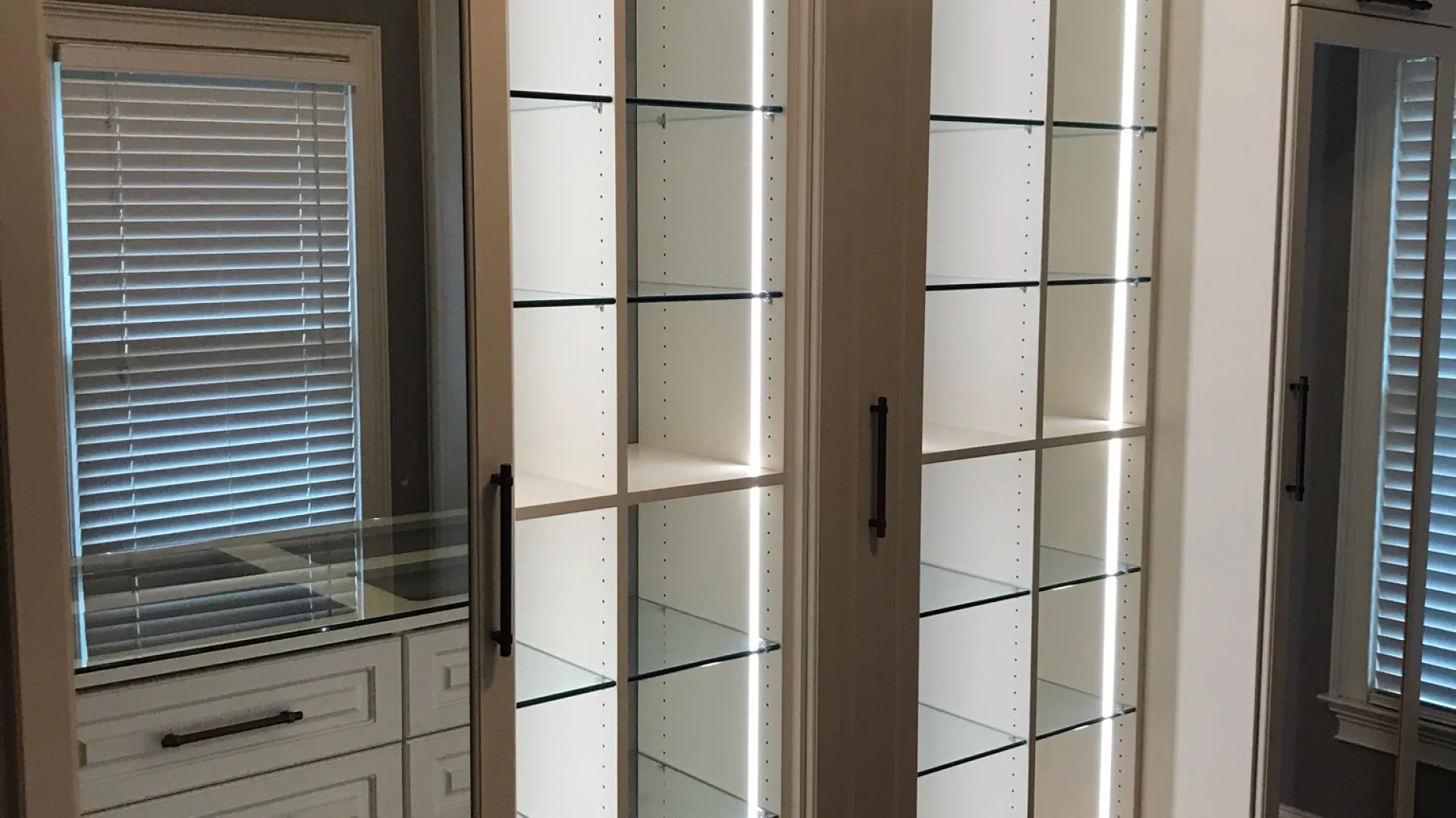 a white cabinet with glass doors