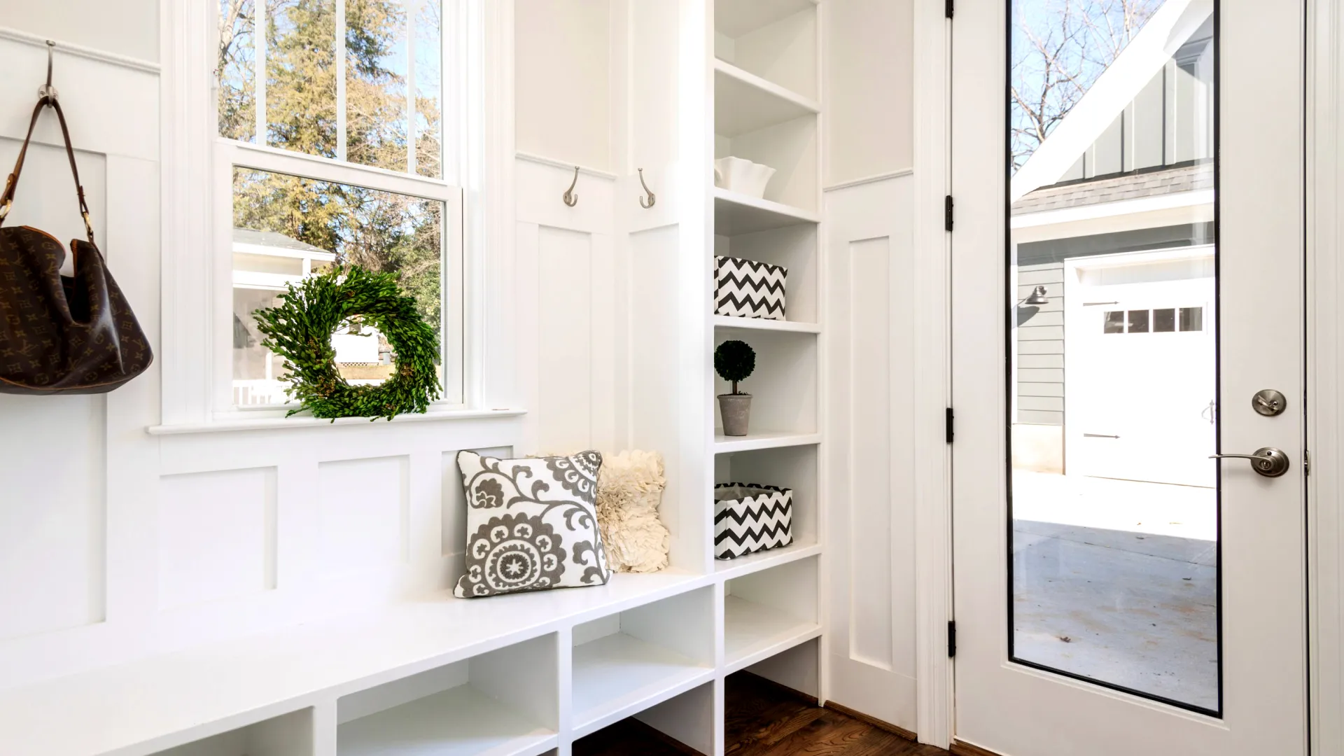 a white shelving unit with a window and a door