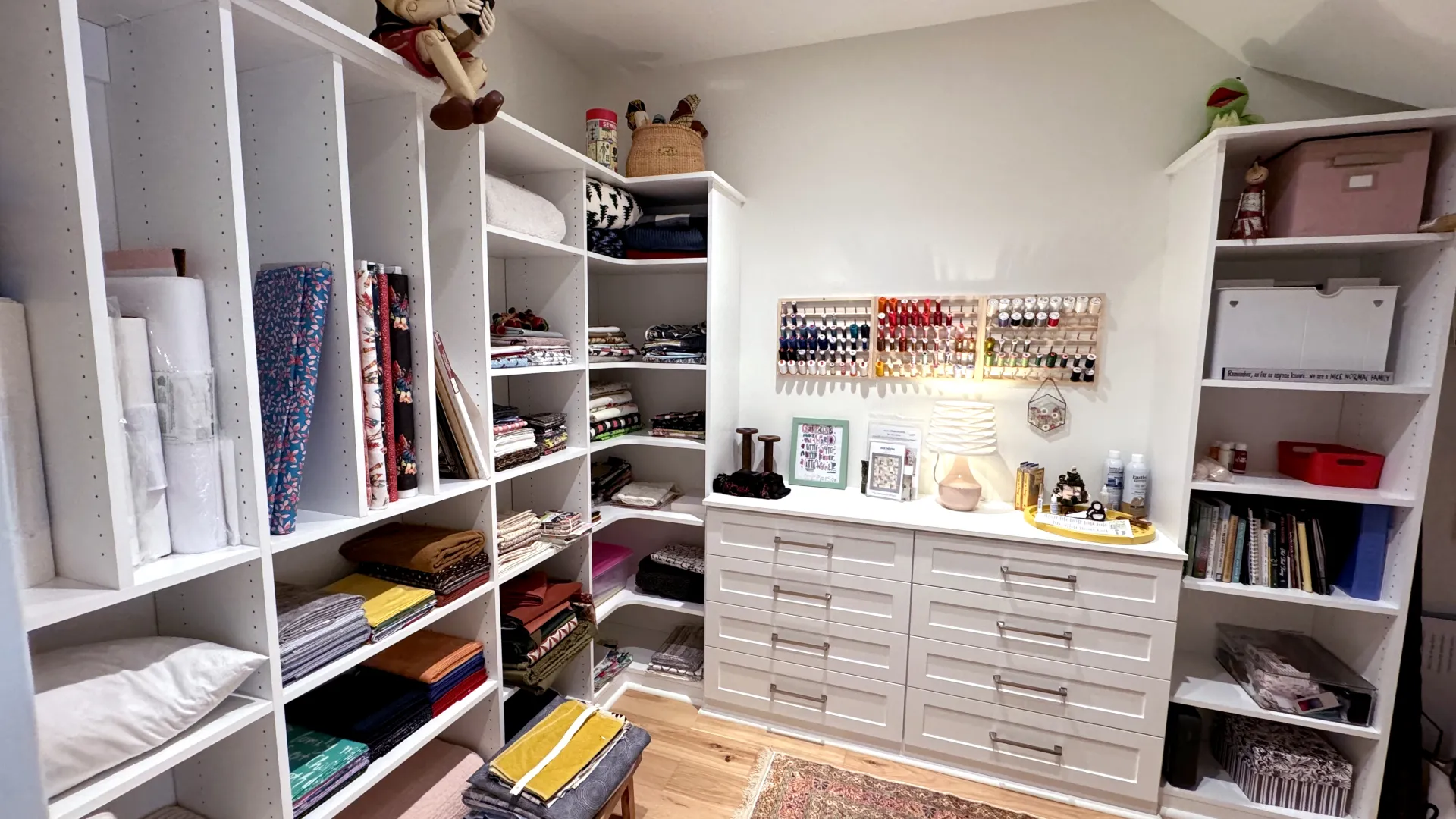 a custom craft room with shelves for storage