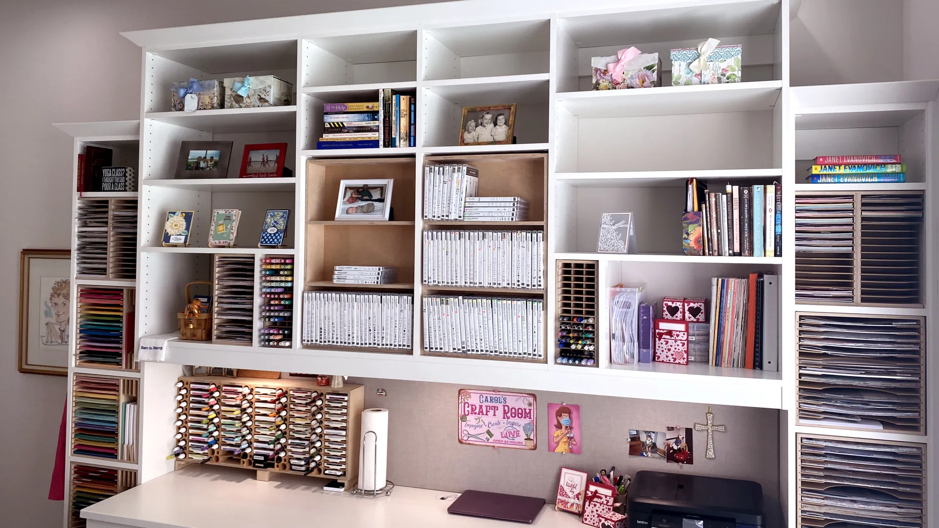 a white shelving unit with books