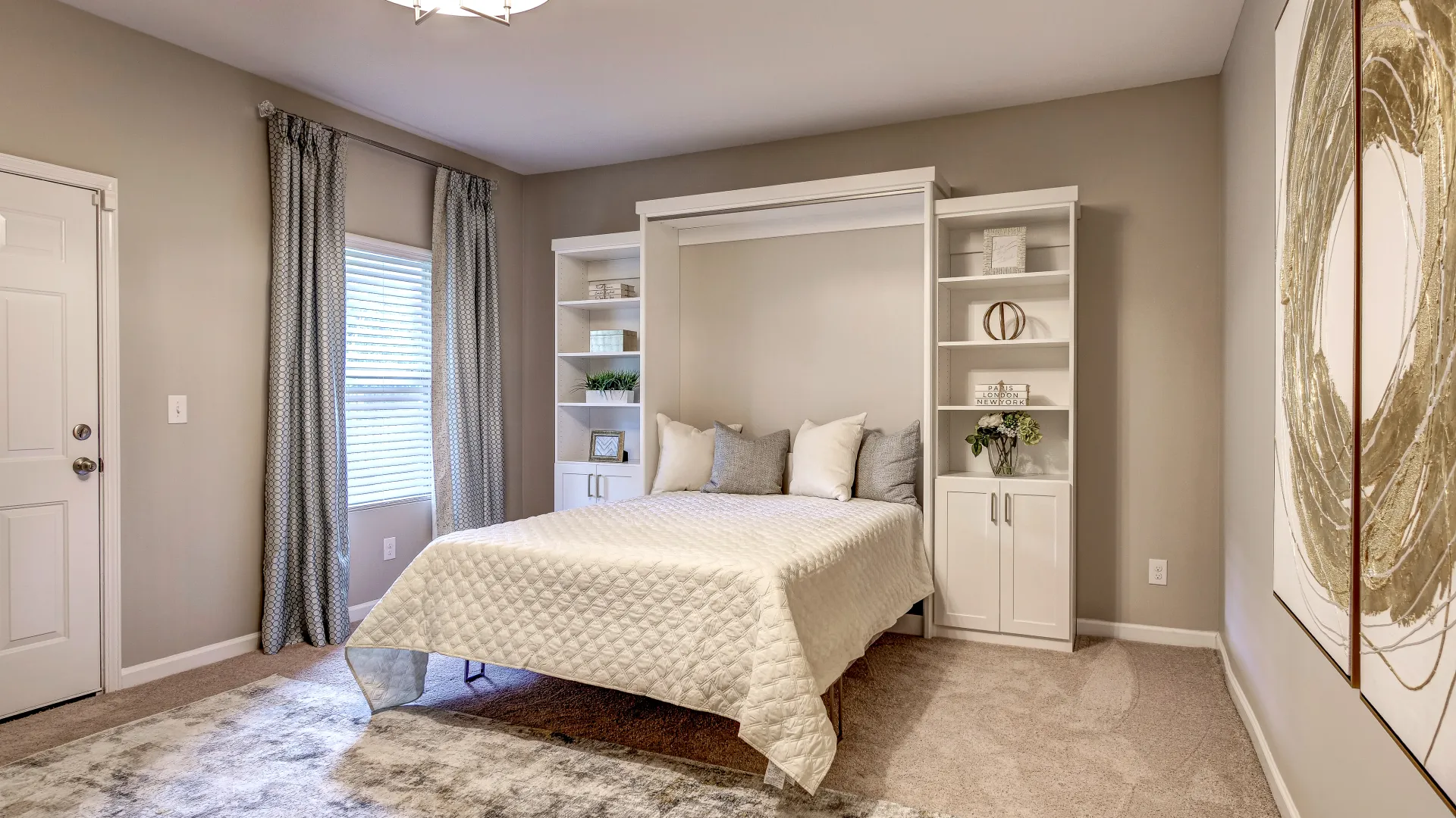 Modern bedroom with Murphy bed or wall bed, built-in cabinets, built-in shelves and modern decor.