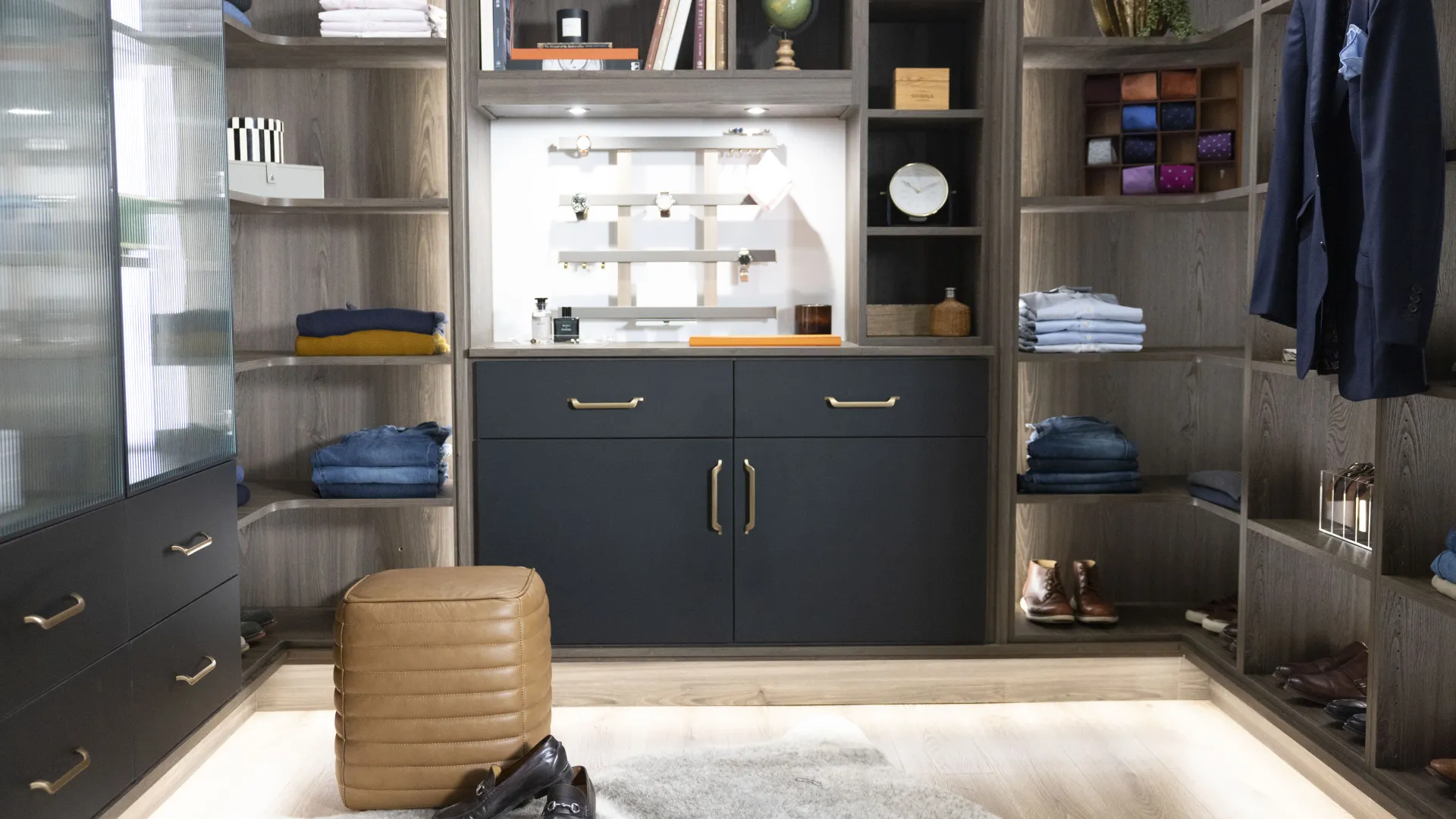 a closet with a chair and a shelf with clothes on it