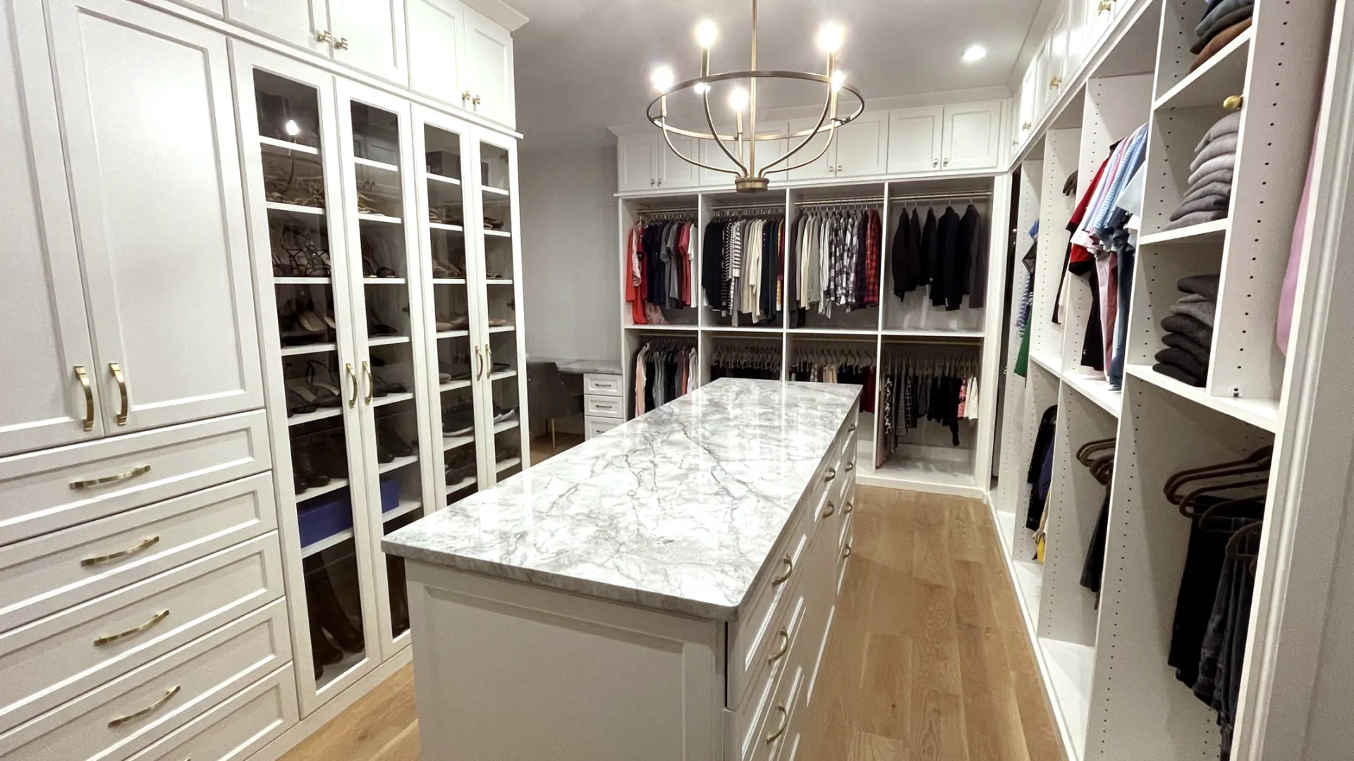 a custom closet with a mable countertop