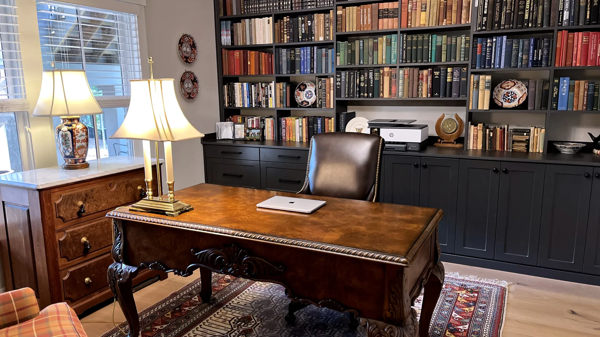 a room with a desk and bookshelves