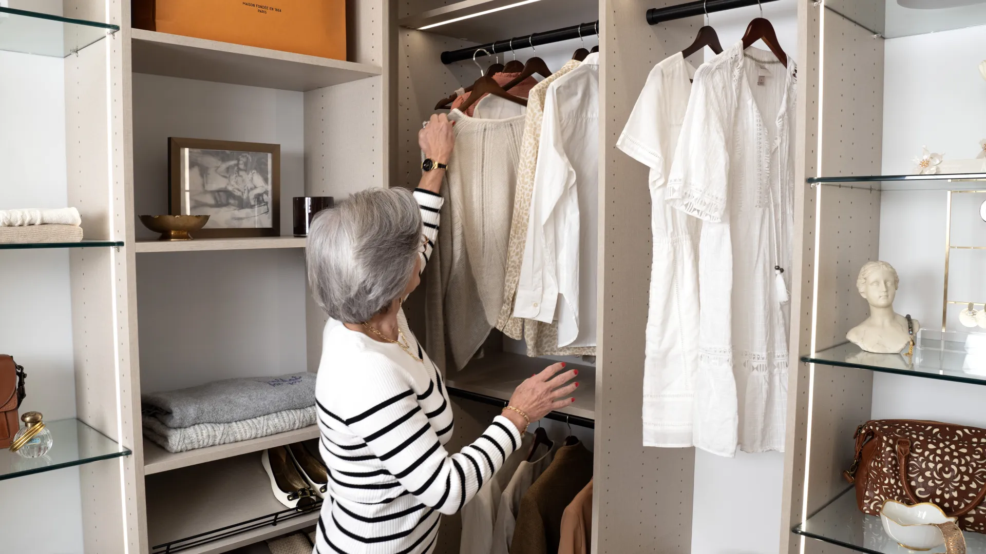 a person looking at a closet full of clothes