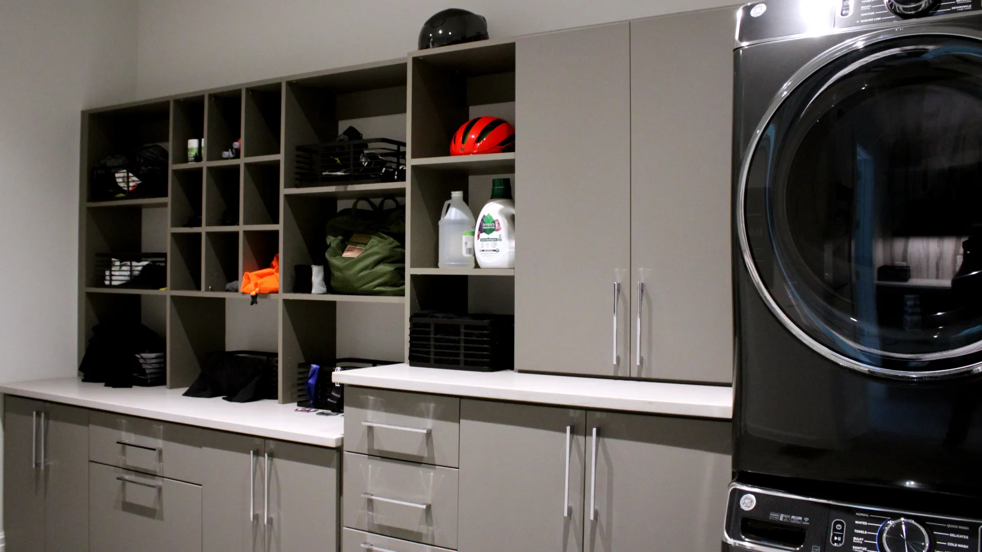 a laundry room with custom storage and cabinets for organization