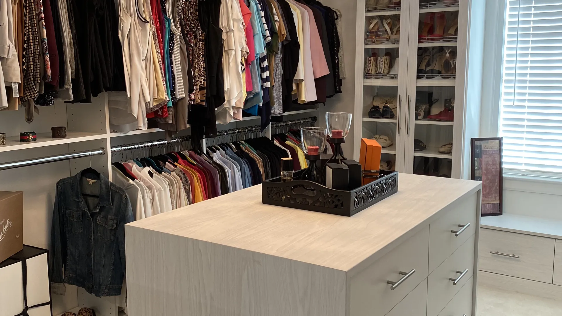 a room with a white counter and a white cabinet with a light above