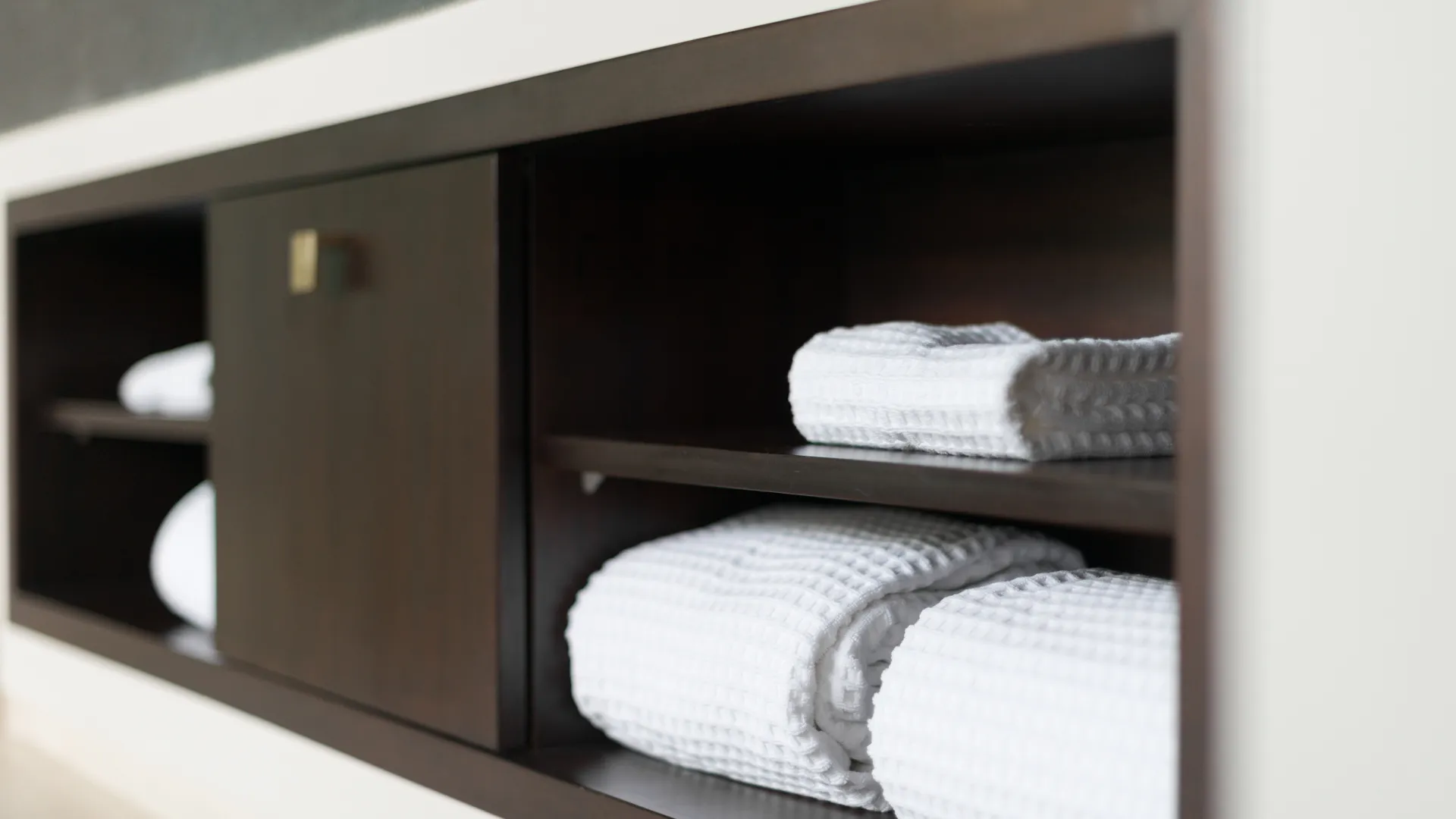 a shelf with towels on it