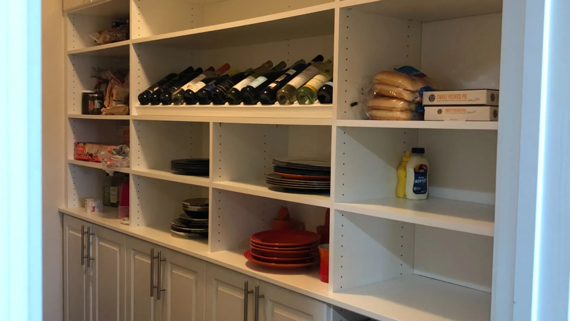 a white refrigerator with many bottles