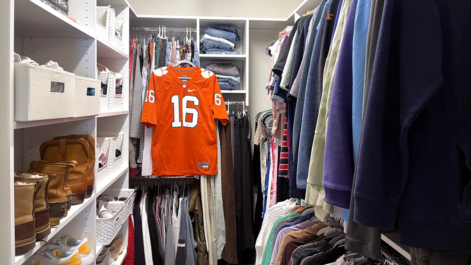 a white custom closet full of clothes including a clemson university football jersey