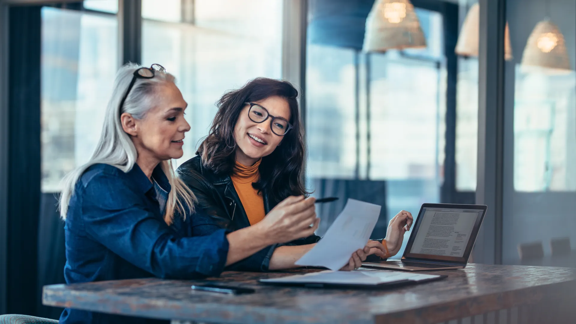 a few women looking at a laptop