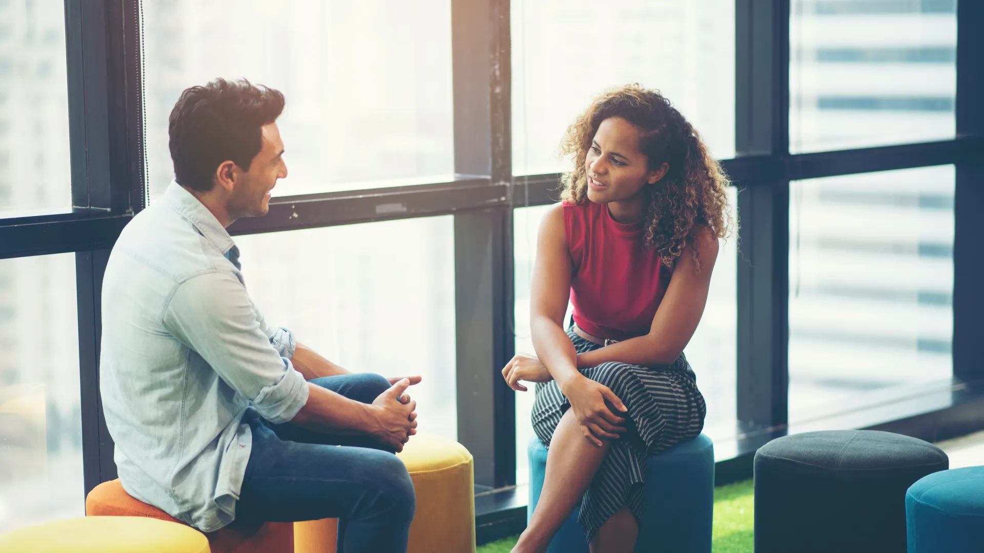 a man and a woman sitting on stools
