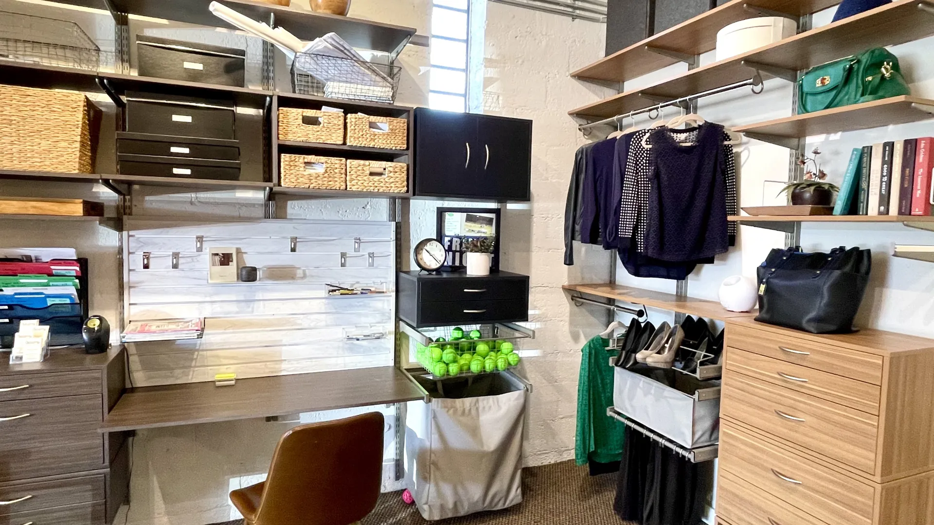 Well-organized home office and closet space with shelves, storage bins, hanging clothes, shoes, and a desk with chair.