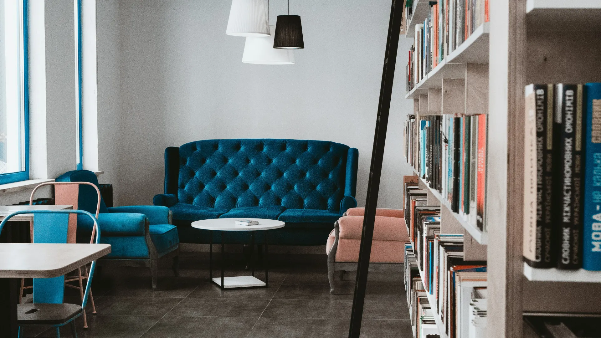 a room with bookshelves and chairs