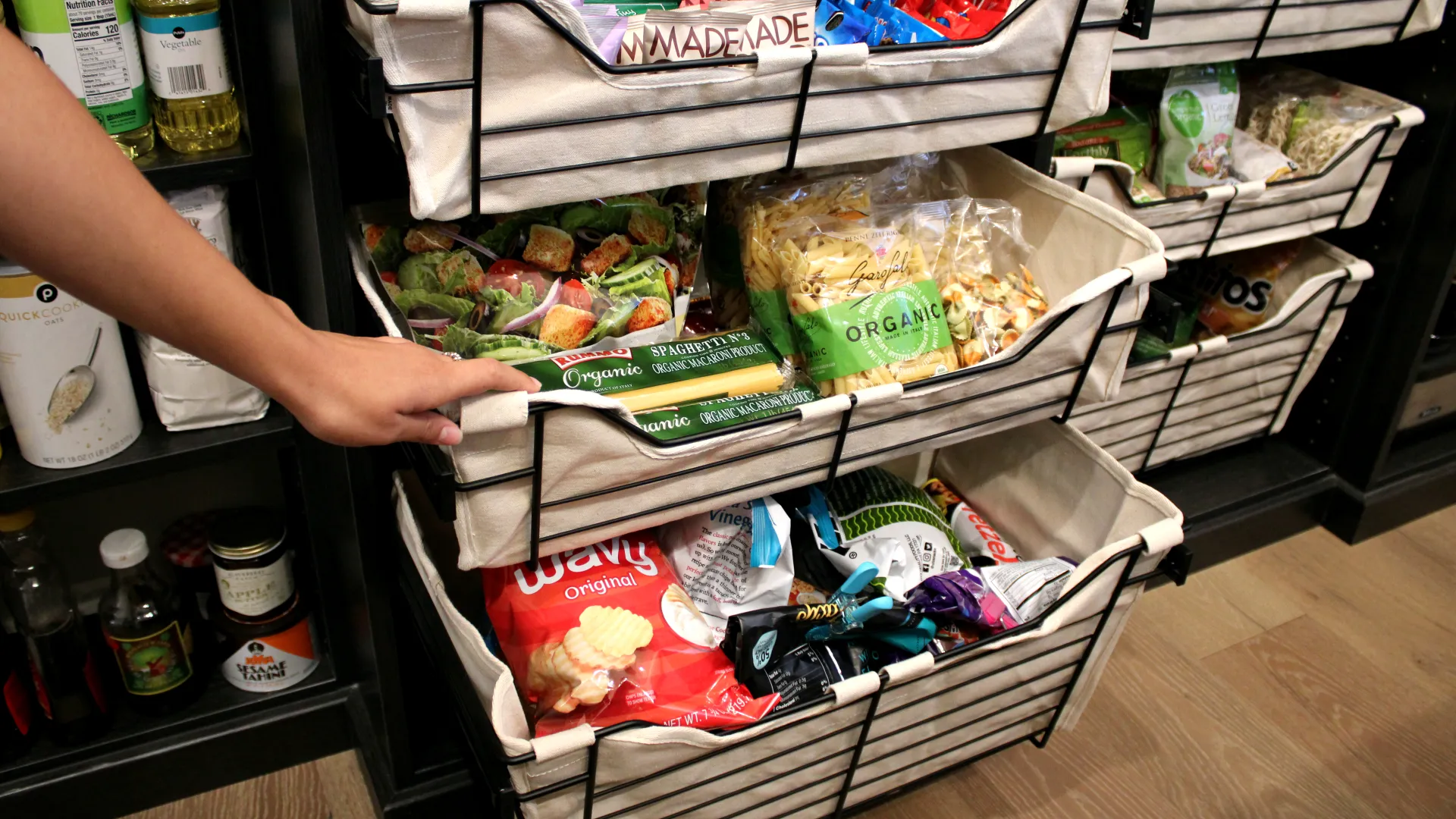 a person pushing a shopping cart full of food